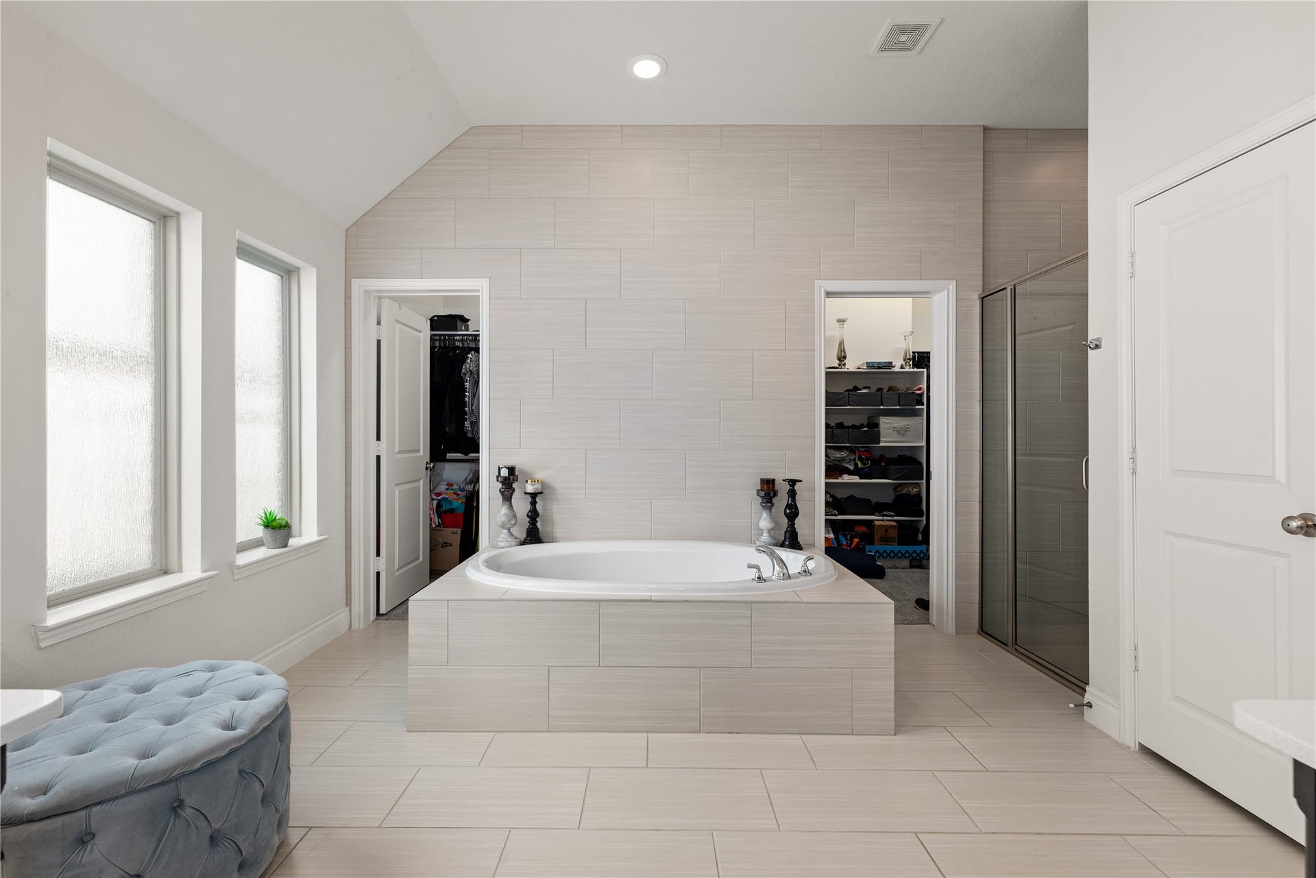 2419 Elmwood Trail, Katy, TX 77493 Elegant primary bathroom featuring a soaking tub, separate walk-in shower, high ceilings, and spacious layout. Bright and relaxing space with modern finishes and plenty of room to unwind.