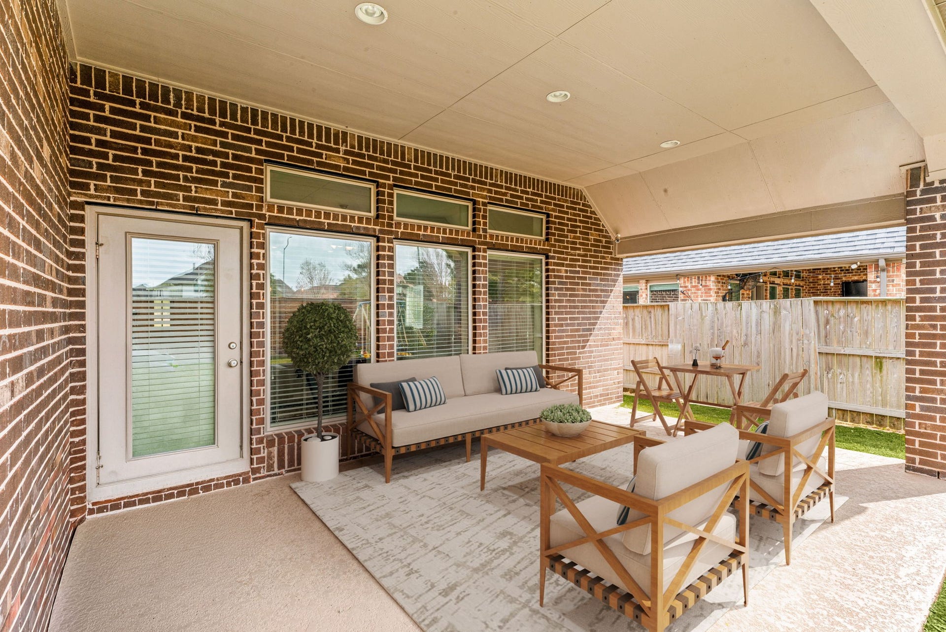 2419 Elmwood Trail, Katy, TX 77493 Covered back patio with plenty of space for outdoor seating, perfect for relaxing or entertaining. Features brick exterior, ceiling lights, and a private backyard with room to enjoy year-round.