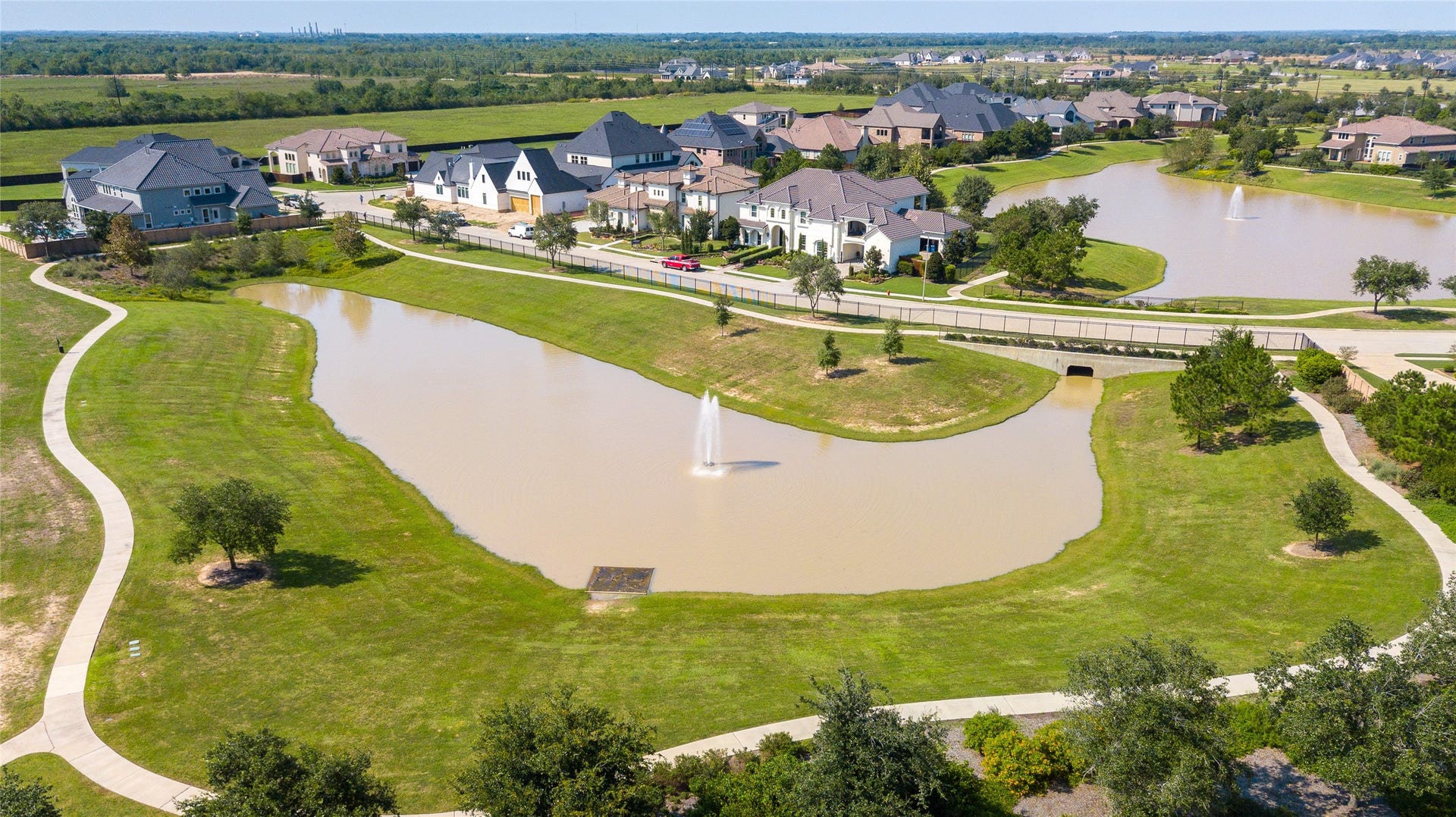 2419 Elmwood Trail, Katy, TX 77493 Scenic walking trails wind along sparkling waters, creating the perfect setting for morning strolls, evening sunsets, and a peaceful connection to natureall just steps from home.