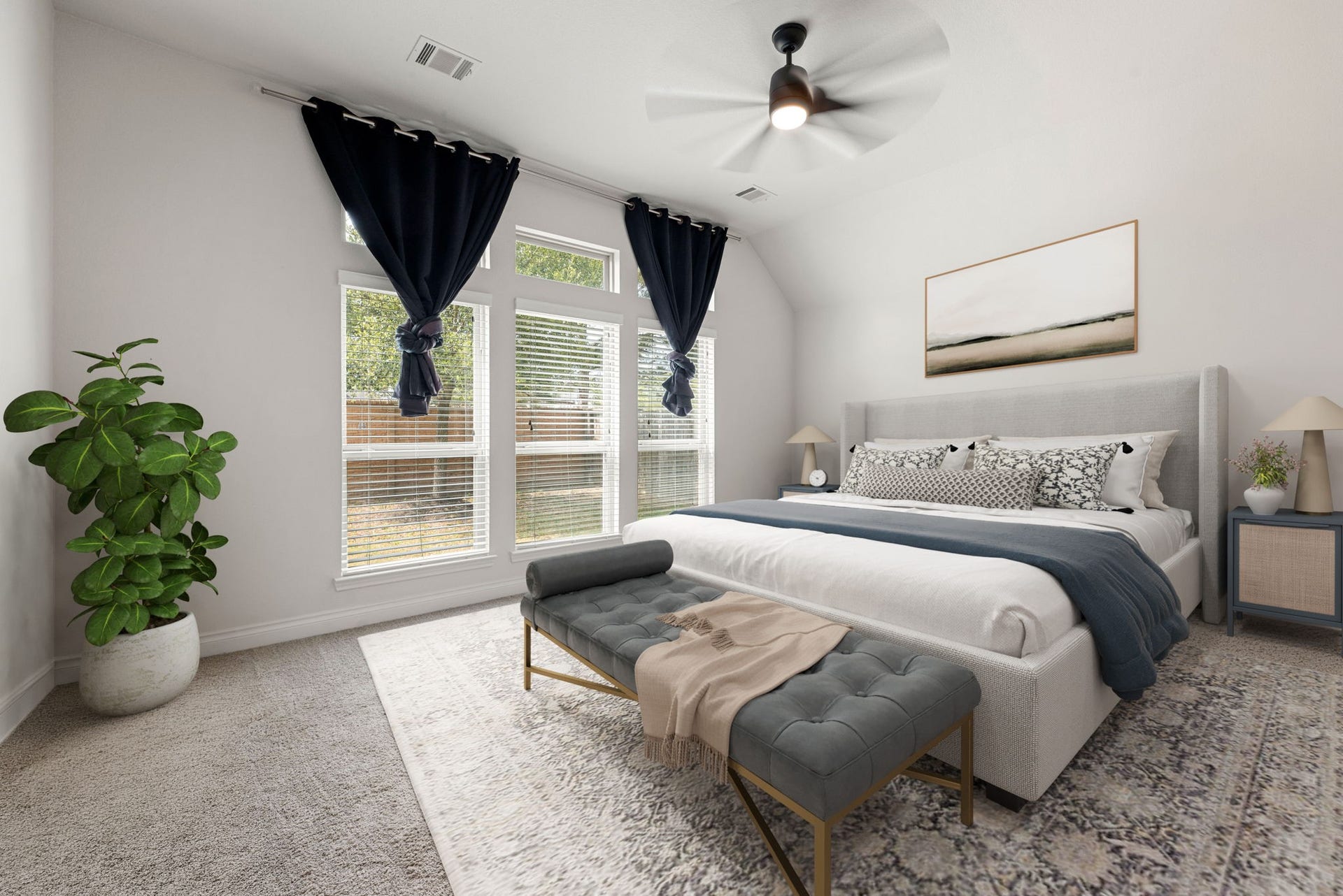 2419 Elmwood Trail, Katy, TX 77493 Spacious primary bedroom with high ceilings, large windows for natural light, plush carpet, and a ceiling fan. Bright and comfortable retreat with plenty of space to relax.