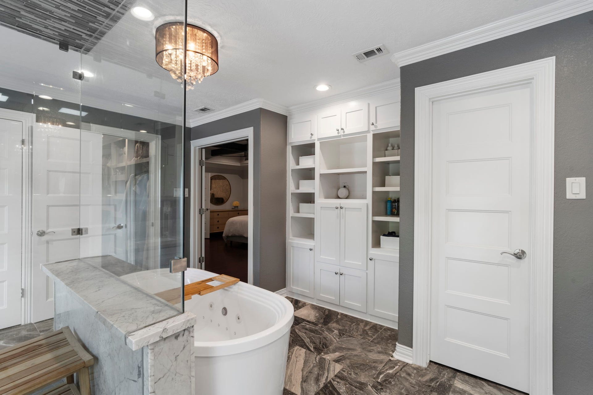 9 Charleston Street S, Sugar Land, TX 77478 Built-in storage cabinets and shelving provide ample space for linens, toiletries, and everyday essentials while maintaining a clean, sophisticated look.