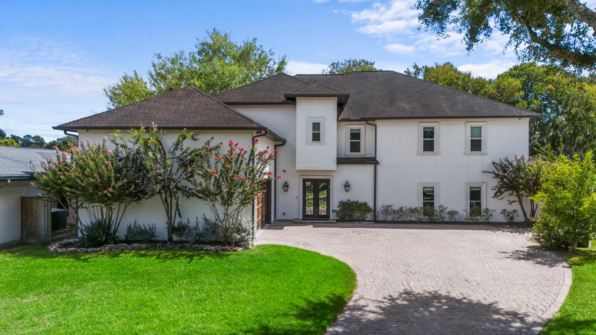 9 Charleston Street S, Sugar Land, TX 77478 A wide driveway provides ample space for multiple vehicles and guests. The climate-controlled garage features a commercial-grade door and opener, beverage cooler, two Tesla charging plugs, and durable rubber tile flooring.