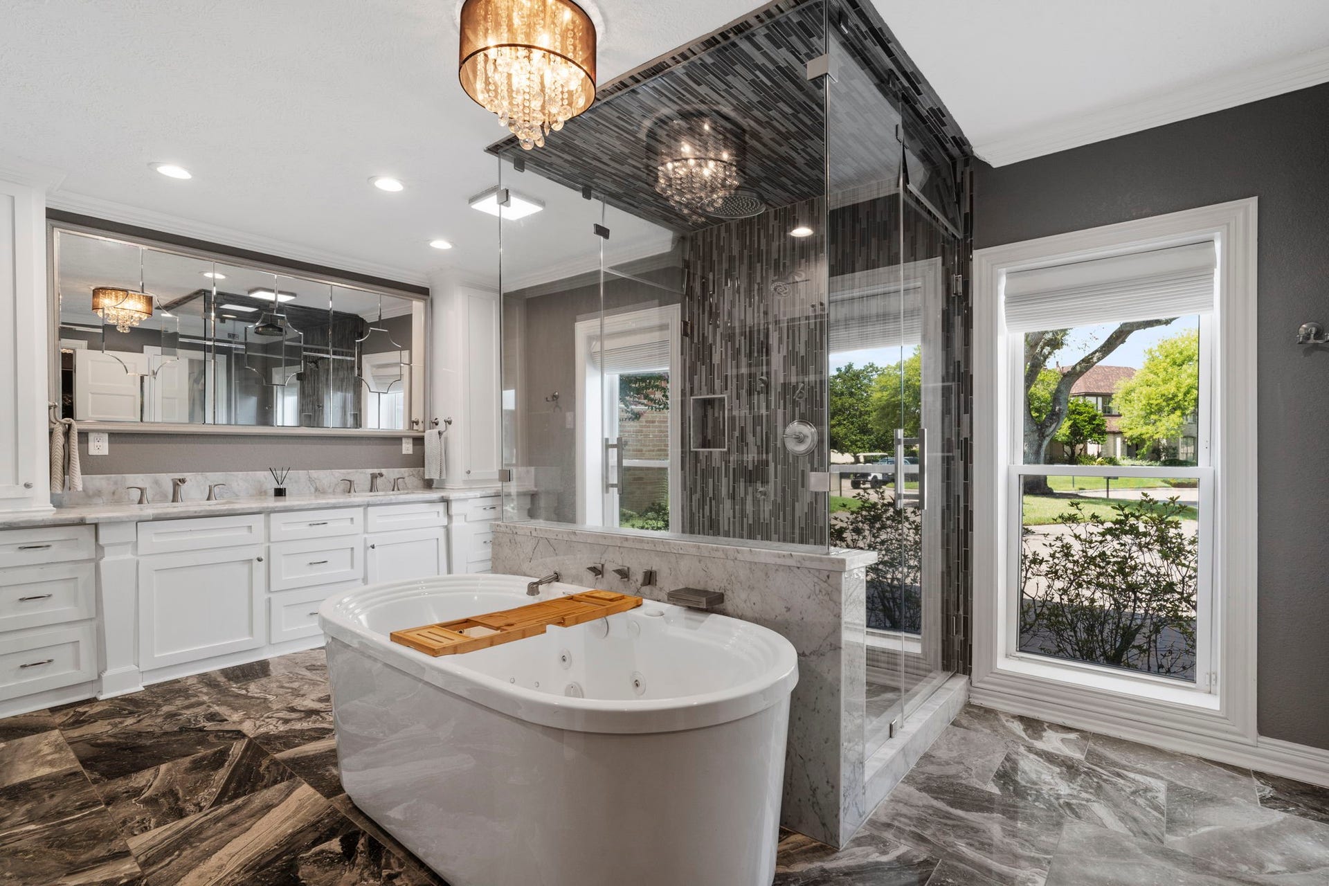 9 Charleston Street S, Sugar Land, TX 77478 Step inside the owners bath, where a jetted freestanding tub, spacious glass-enclosed walk-in shower, and dual vanities create a relaxing retreat.