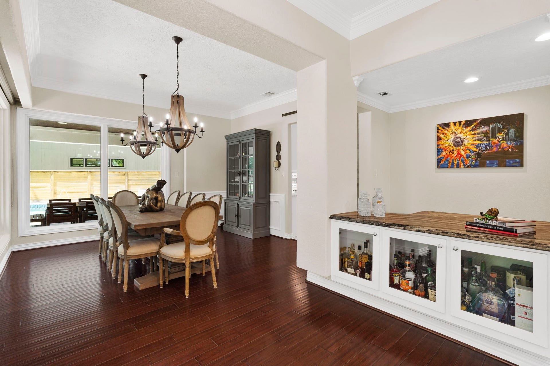 9 Charleston Street S, Sugar Land, TX 77478 The spacious living room flows naturally into the dining room, with a cocktail bar providing a stylish connection between the two spaces.