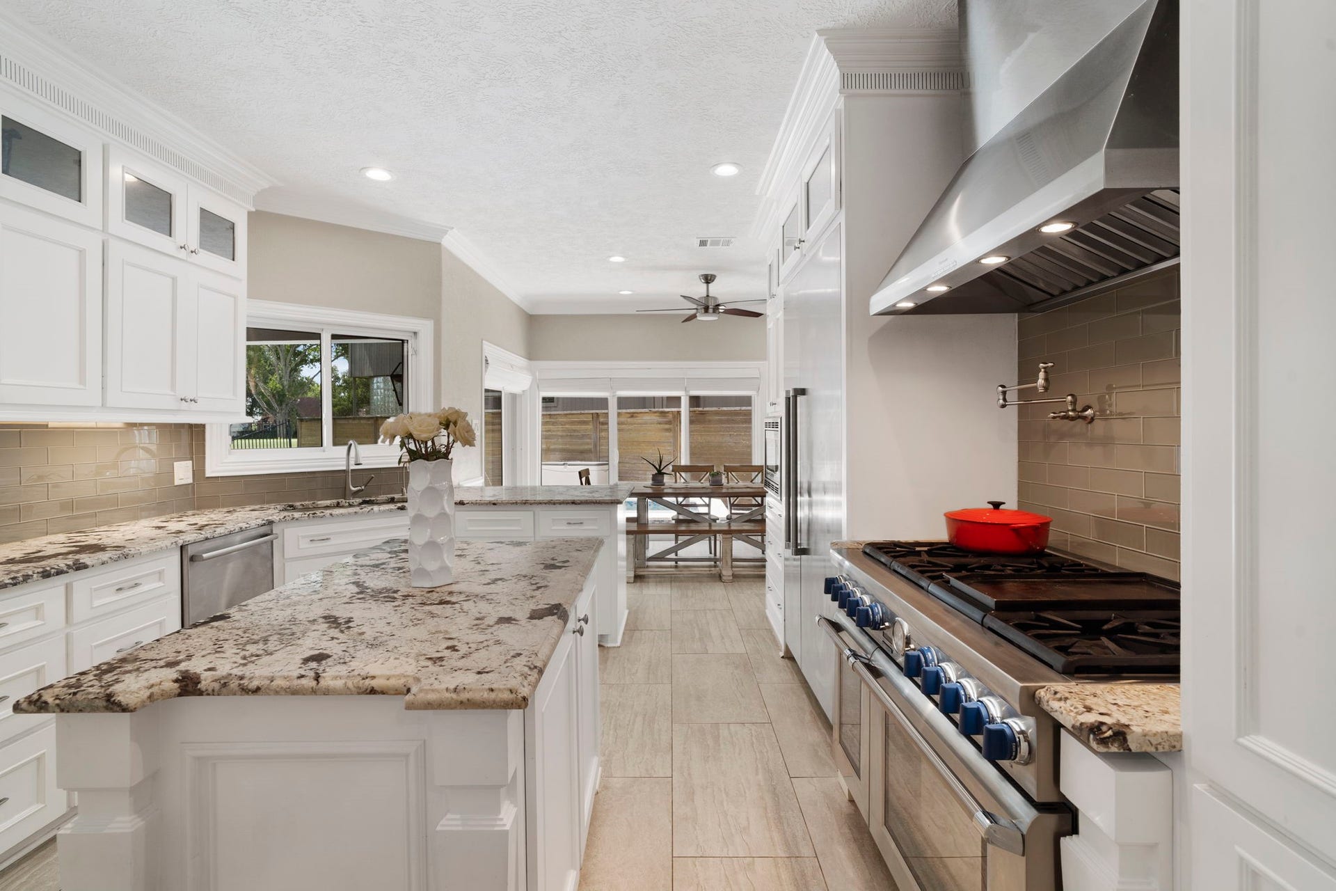 9 Charleston Street S, Sugar Land, TX 77478 The well-designed kitchen features a center island, large walk-in pantry, recessed and under-cabinet lighting, and a convenient breakfast bar.