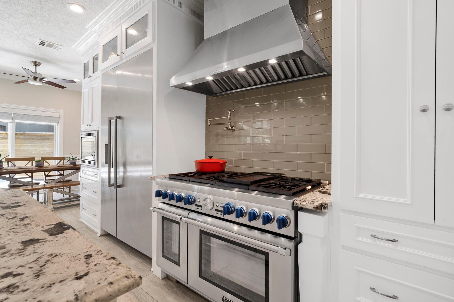 9 Charleston Street S, Sugar Land, TX 77478 The heart of the home is the beautifully appointed kitchen, showcasing high-end Thermador and Bosch appliances complemented by sophisticated leather-finish granite countertops.