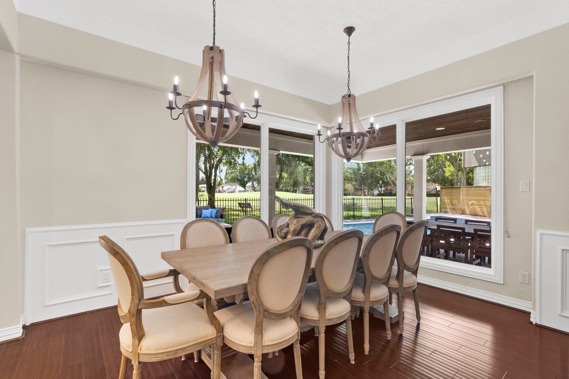 9 Charleston Street S, Sugar Land, TX 77478 Matching farmhouse-style candle chandeliers add warmth and character to the dining room, while large windows frame beautiful views for family and guests to enjoy.