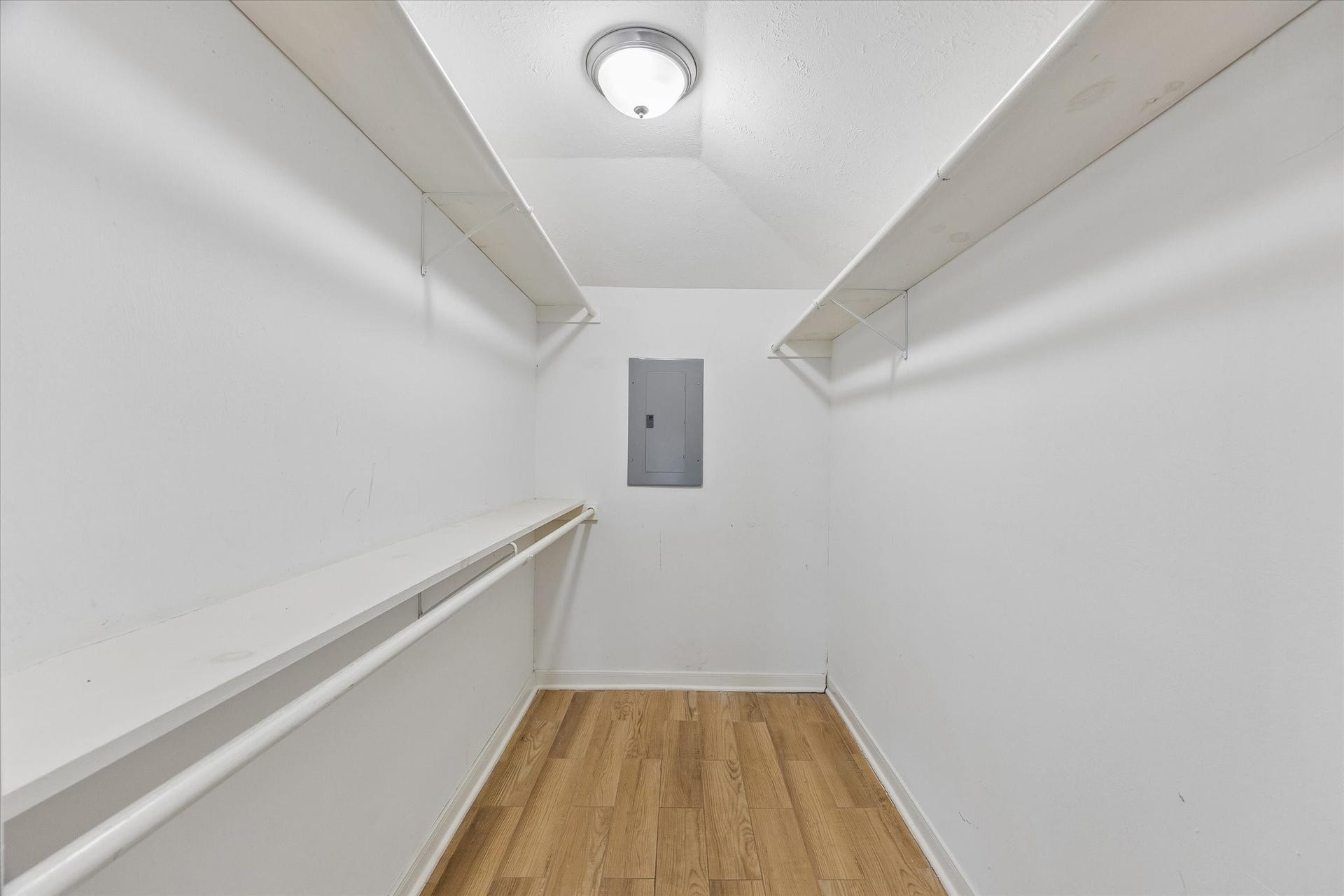 5119 PATRICK HENRY, Bellaire, TX 77401 Spacious walk-in closet with hanging rods and ample shelving.