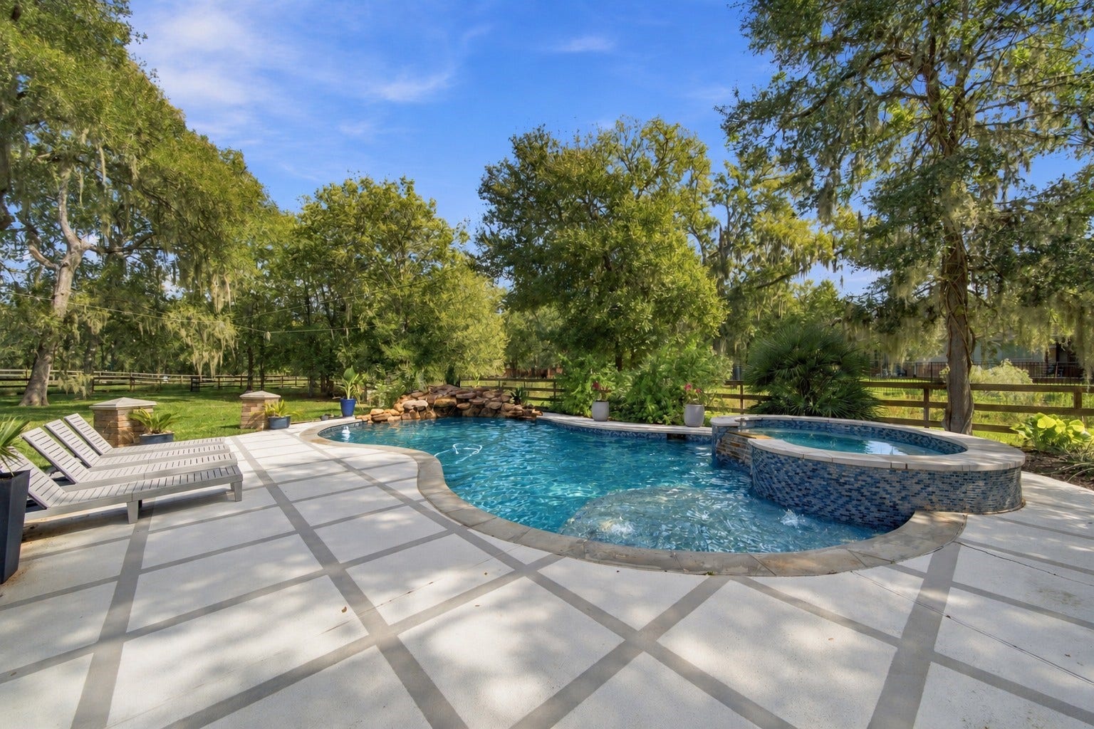32703 Wales Circle, Fulshear, TX 77441 A sparkling pool and spa complete the backyard retreat, creating an inviting setting for sunny afternoons and relaxing evenings.