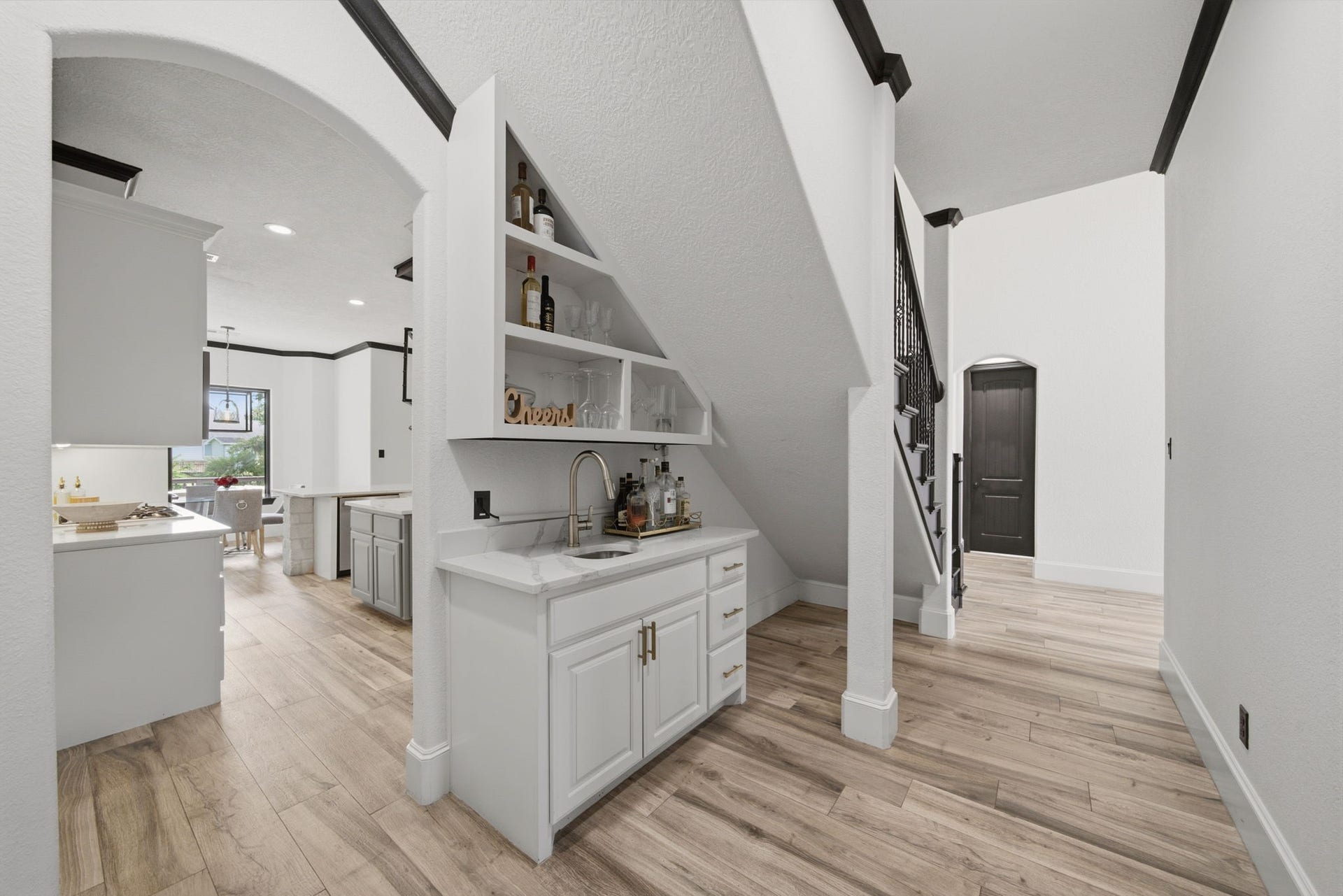 32703 Wales Circle, Fulshear, TX 77441 Thoughtfully tucked beneath the stairs, this wet bar adds charm and convenience for effortless entertaining.