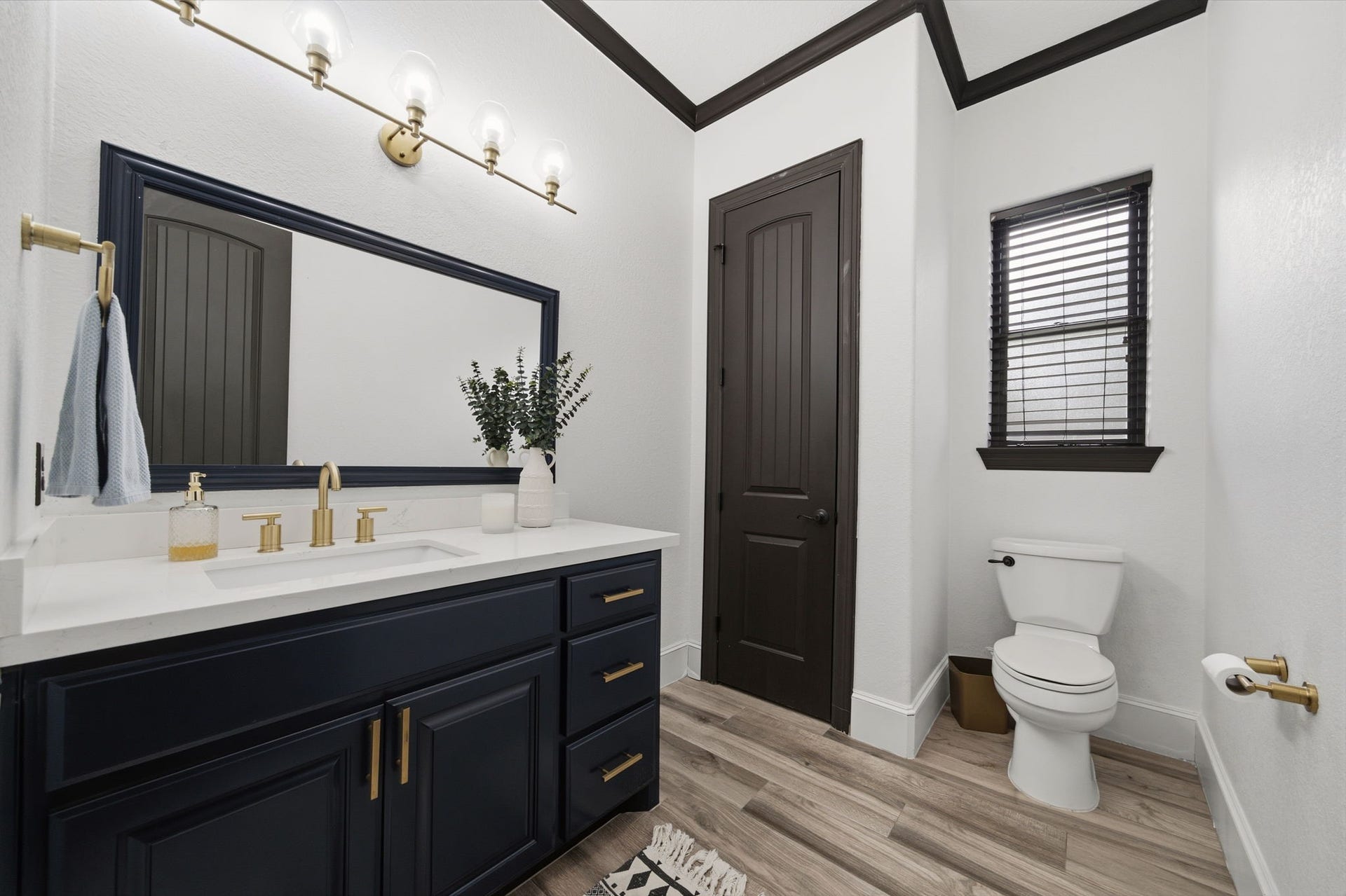 32703 Wales Circle, Fulshear, TX 77441 Updated cabinetry, countertops, and lighting give this half bath a fresh, polished look.