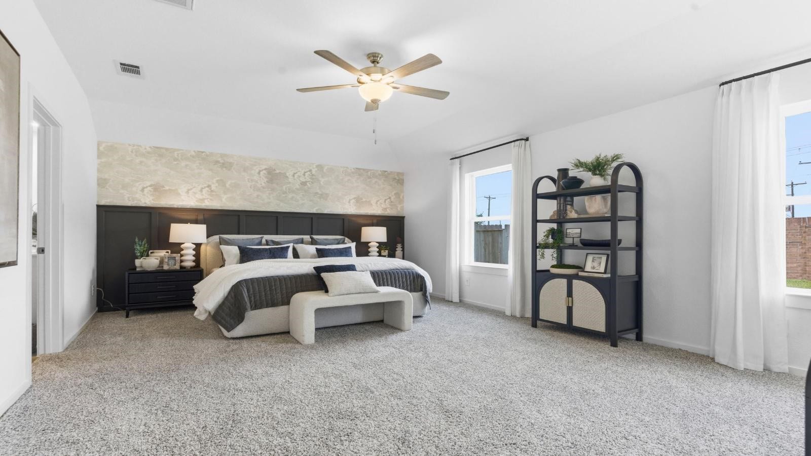 14223 Starboard Reach Drive, Texas City, TX 77510 A spacious primary bedroom emphasizing open space and natural lighting with large windows.
