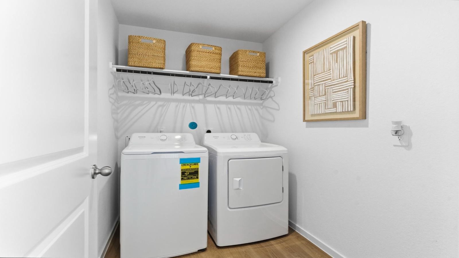 14223 Starboard Reach Drive, Texas City, TX 77510 Spacious laundry room with washer and dryer connections, hanging rod, and vinyl wood flooring