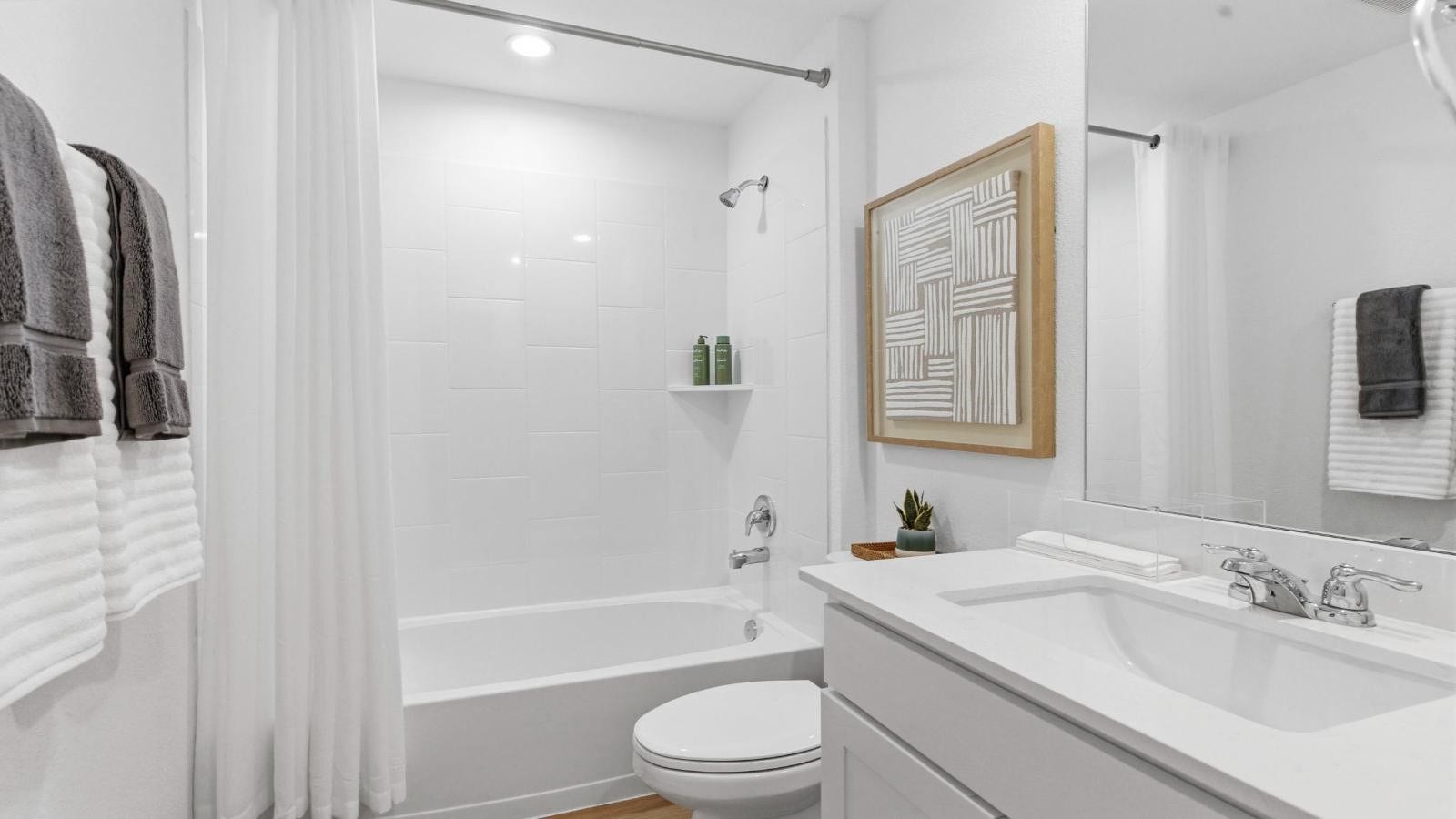 14223 Starboard Reach Drive, Texas City, TX 77510 A well-designed bathroom equipped with quartz countertops, a standing tub, and a single vanity.