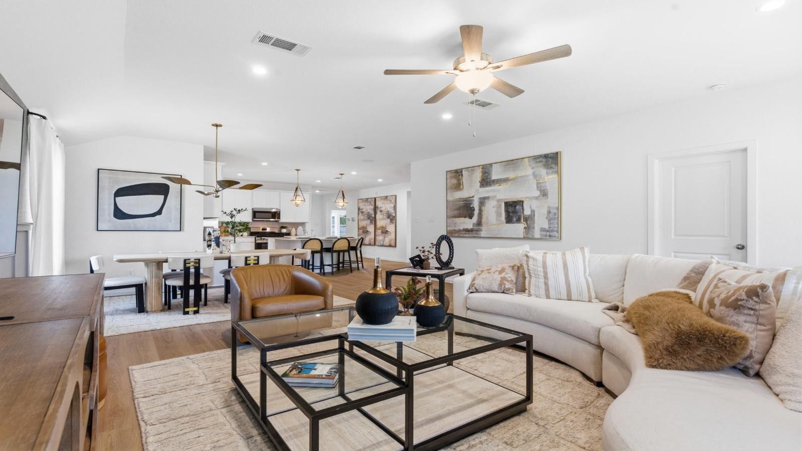 14223 Starboard Reach Drive, Texas City, TX 77510 A cozy living room featuring large windows for natural lighting, vinyl wood flooring and a view to the kitchen and dining area.