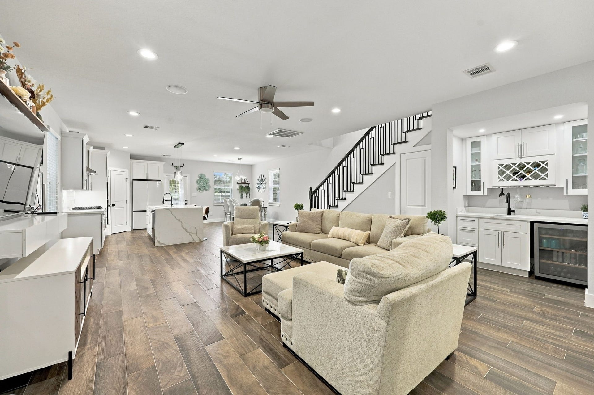 1116 Bennington Street, Houston, TX 77022 Spacious open-concept living area featuring a modern kitchen with large island and a stylish wet bar with wine storageperfect for entertaining.
