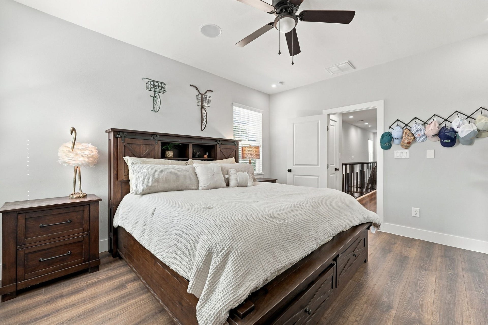 1116 Bennington Street, Houston, TX 77022 Large primary bedroom with overhead lighting and ceiling fan providing a serene retreat.