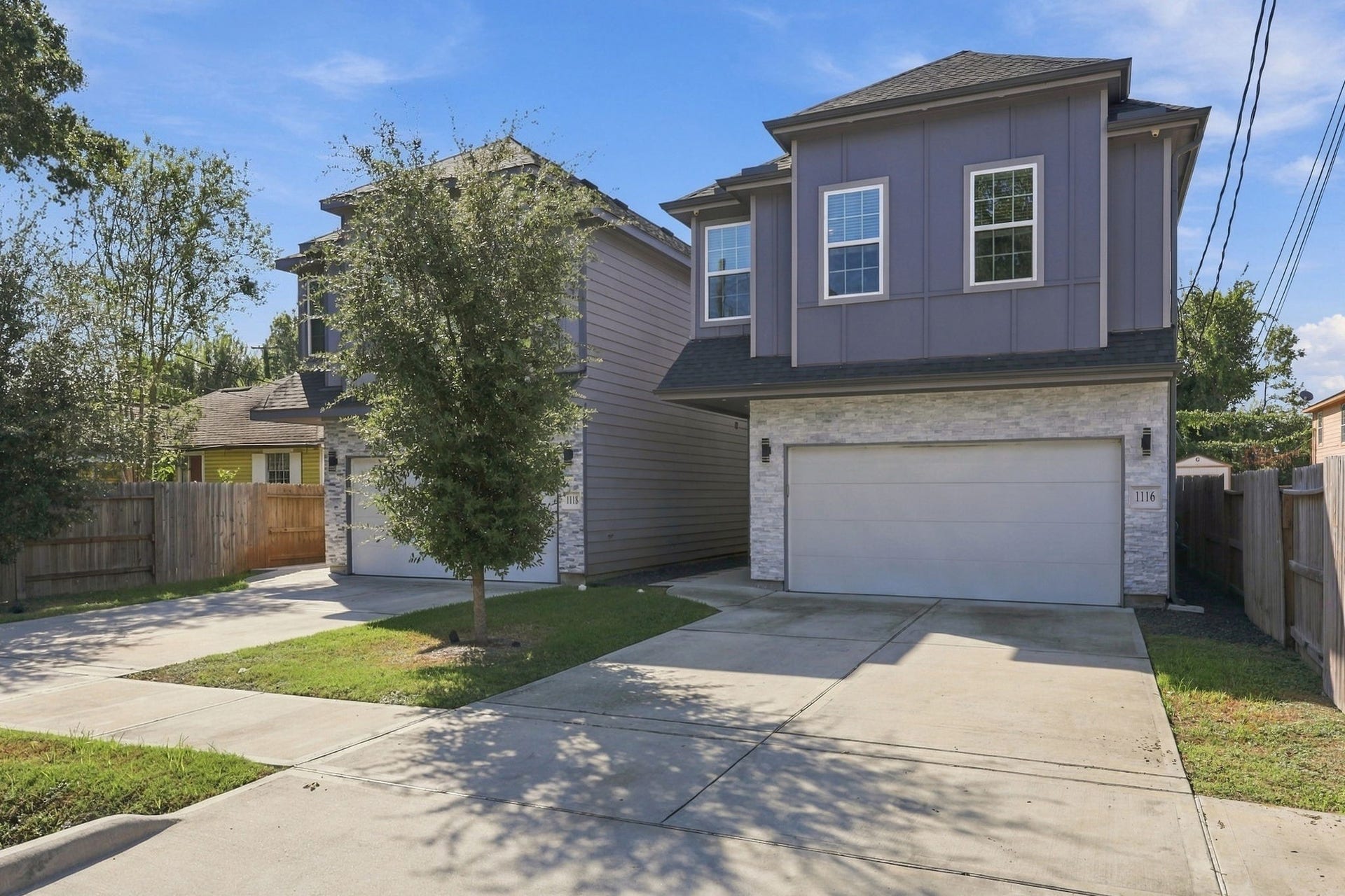 1116 Bennington Street, Houston, TX 77022 Modern two-story home with a clean-lined faade, contemporary architectural details, stone accents and attached two-car garage.