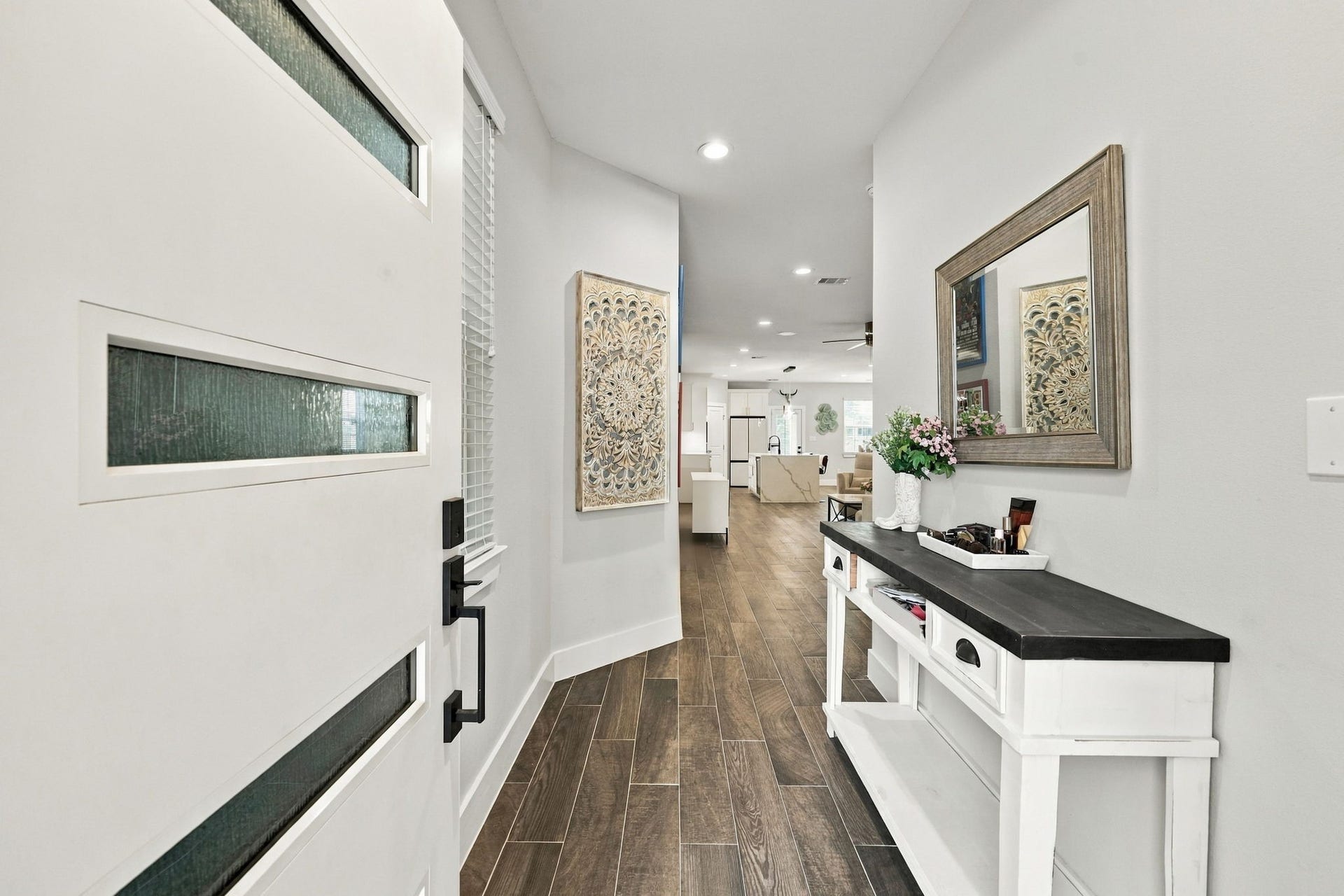 1116 Bennington Street, Houston, TX 77022 Inviting entryway with a modern front door leading into the spacious, open-concept living area.