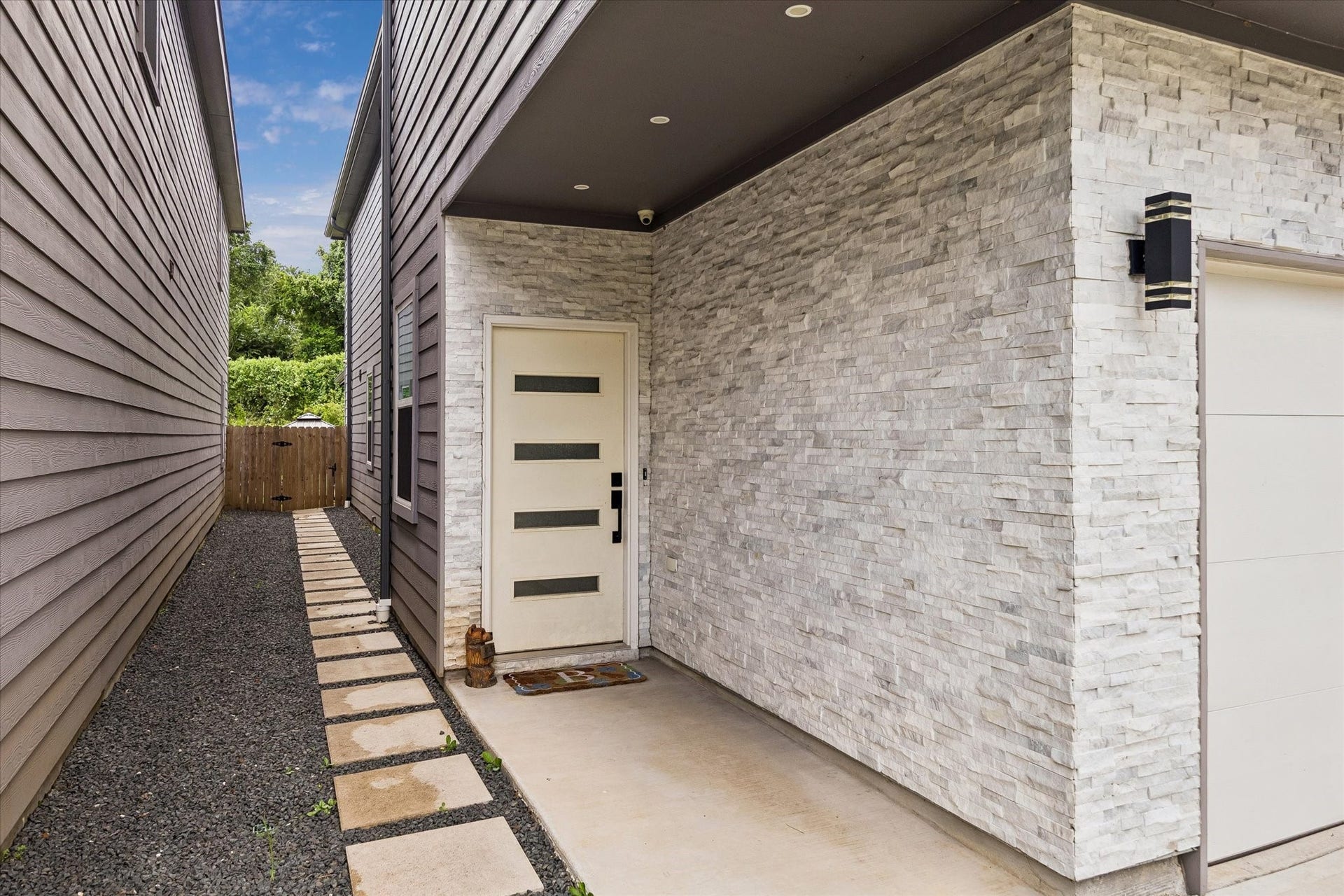 1116 Bennington Street, Houston, TX 77022 Inviting covered entry with modern design, stone accents and stylish exterior lighting.