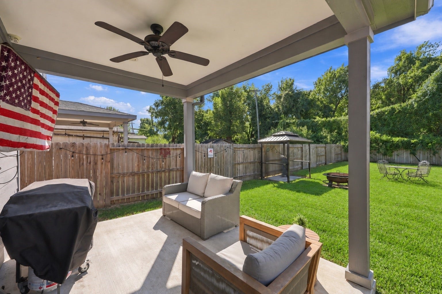 1116 Bennington Street, Houston, TX 77022 Covered back patio with ceiling fan-perfect for outdoor relaxation or entertaining while overlooking the spacious backyard.