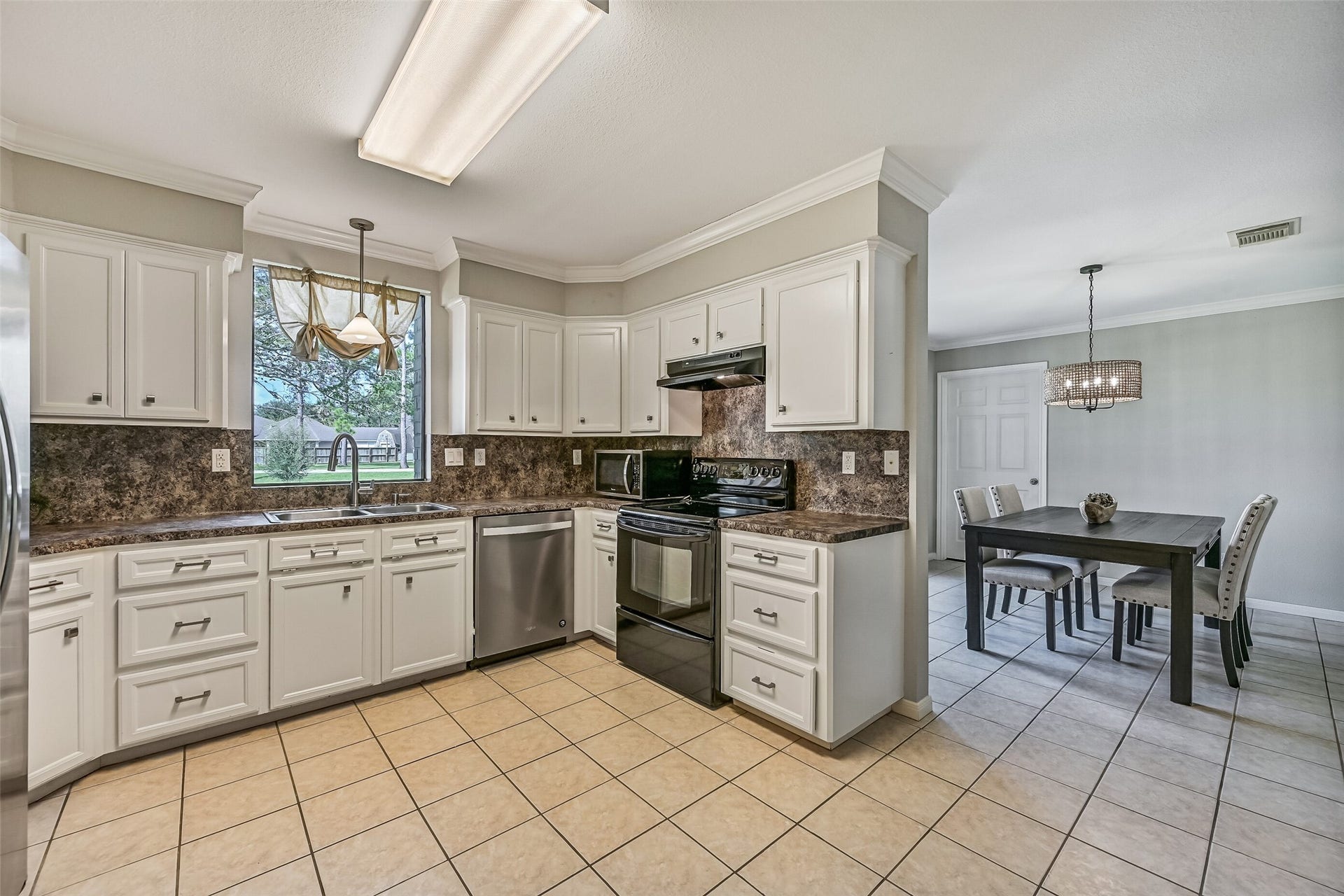 304 Chester Drive, Friendswood, TX 77546 Kitchen Second Residence:
The bright & functional kitchen boasts abundant cabinetry, generous granite-look countertops, and a full appliance package that includes a smooth glass cooktop. A window over the sink brings in natural light and views of the front yard.