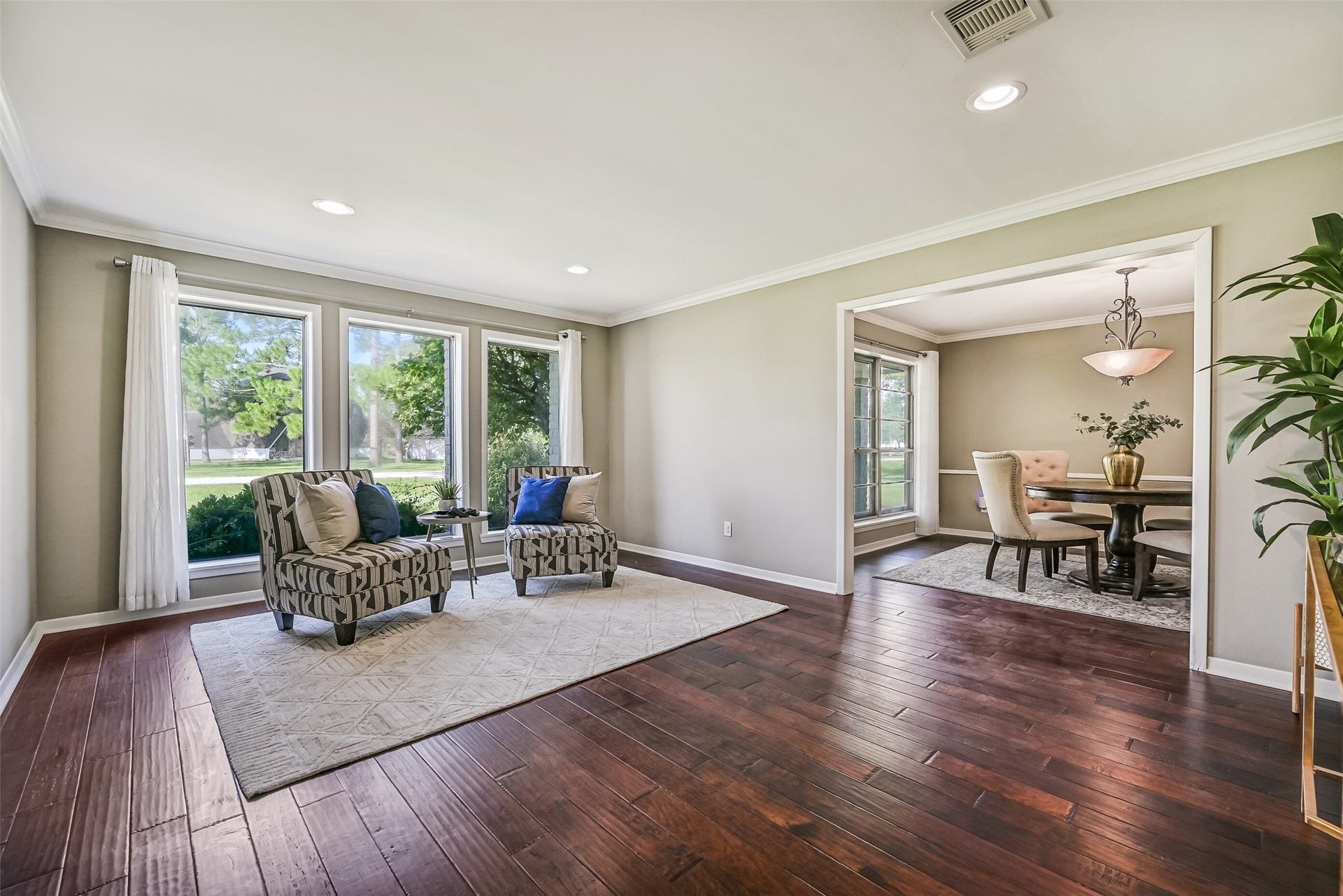304 Chester Drive, Friendswood, TX 77546 Formal Living & Dining First Residence:
Gather in the formal living room just off the foyer with wood flooring, crown molding, and large windows for natural light, opening seamlessly into the formal dining room for effortless entertaining.