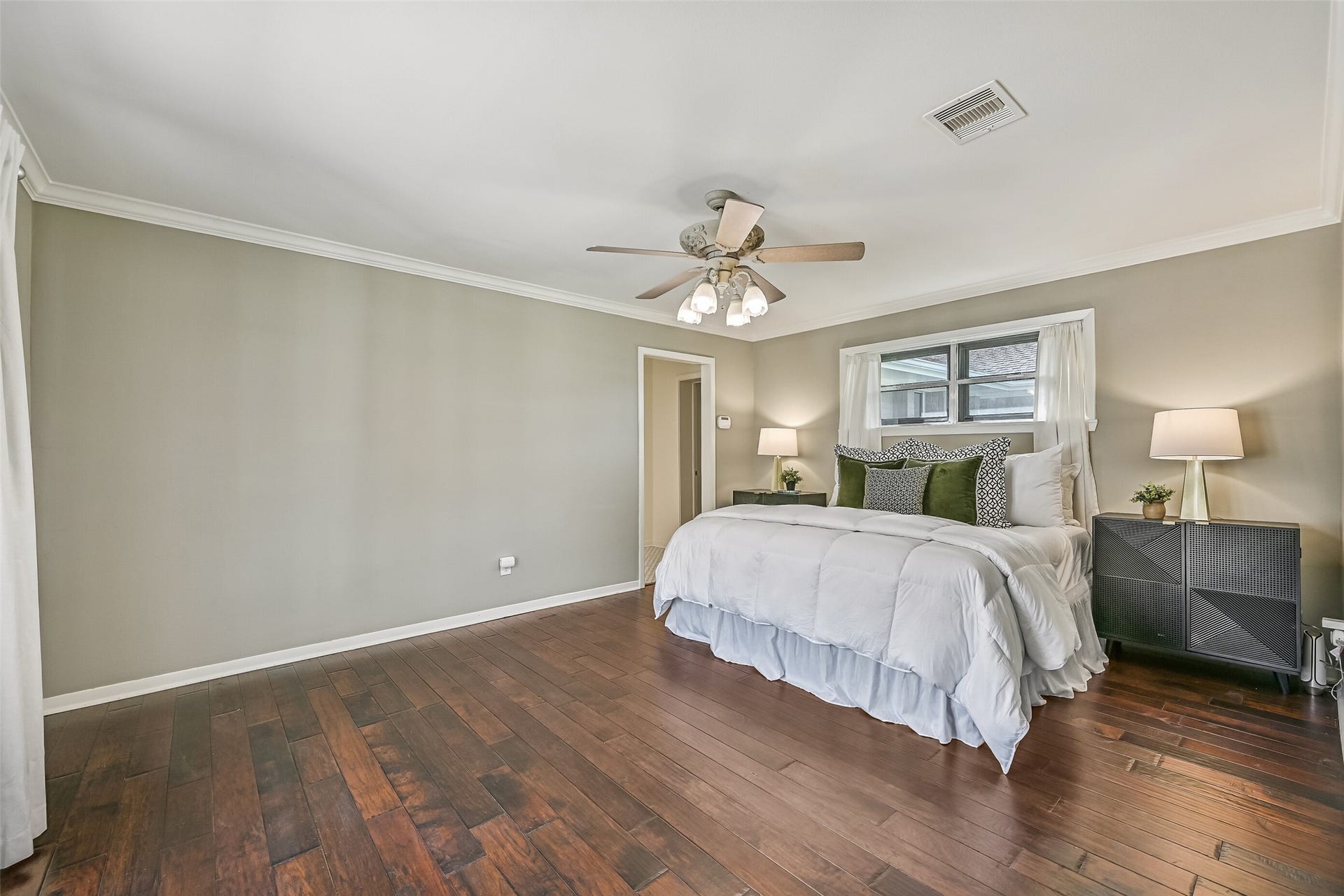 304 Chester Drive, Friendswood, TX 77546 Owners Retreat First Residence:
Escape to the spacious owners retreat featuring rich wood flooring, crown molding, neutral paint tones, and a lighted ceiling fan. Large windows provide natural light & patio views, while the generous layout easily accommodates a sitting area.