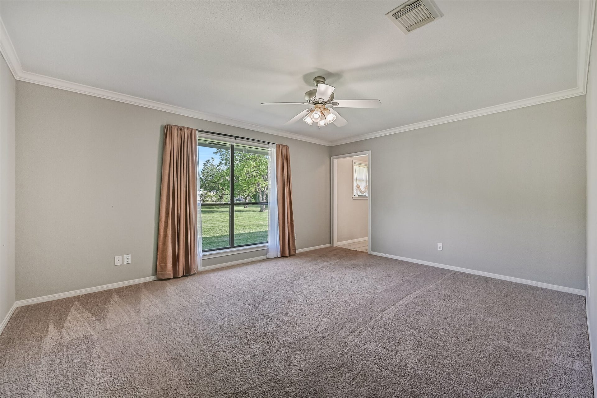 304 Chester Drive, Friendswood, TX 77546 Owners Retreat Second Residence:
The spacious primary bedroom showcases plush carpet, crown molding, and a lighted ceiling fan. Multiple side and rear-facing windows fill the room with soft natural light, creating a bright and restful retreat.