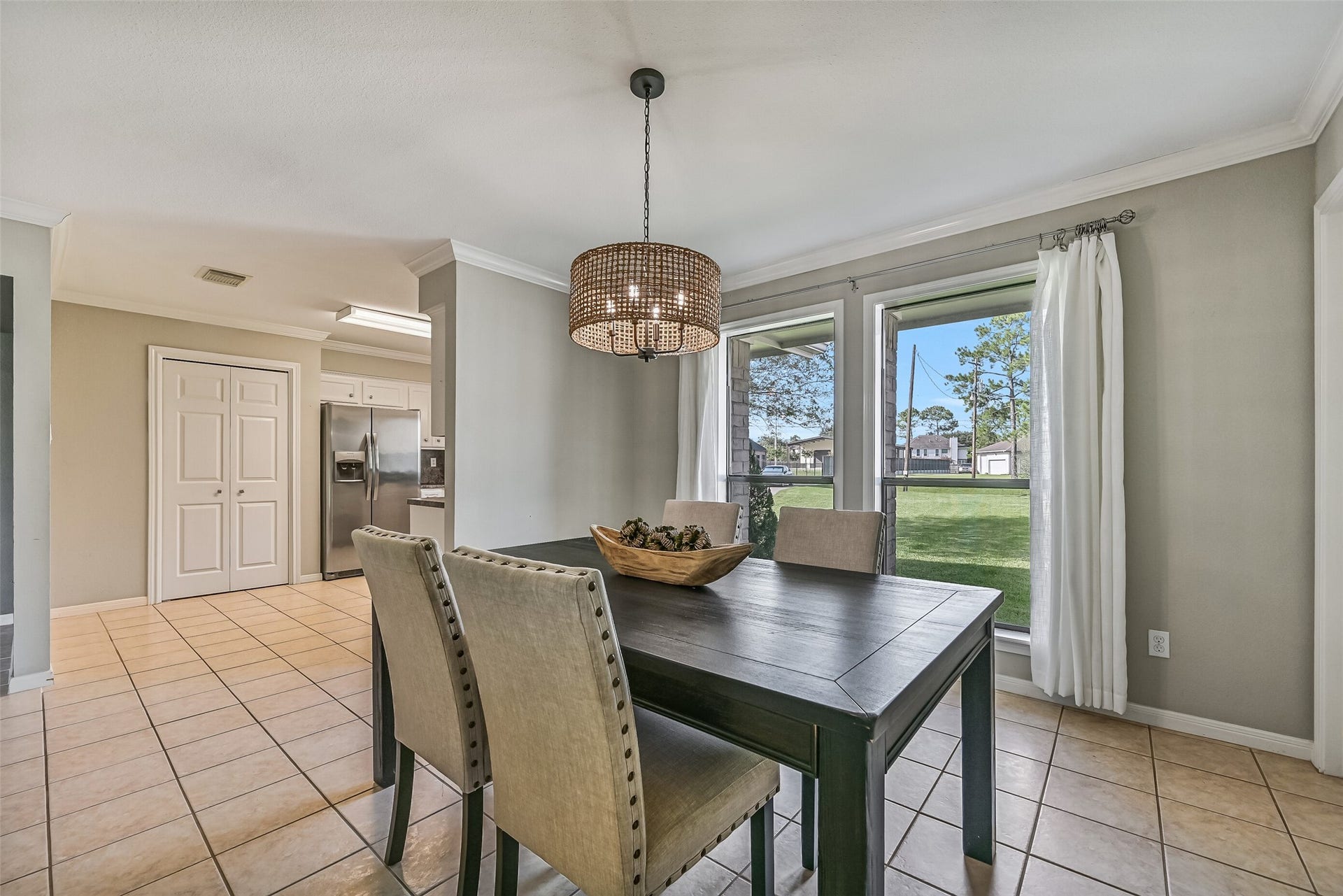 304 Chester Drive, Friendswood, TX 77546 Dining Area Second Residence:
An inviting dining area offers tile flooring, crown molding, and a statement chandelier. Conveniently positioned between the living area and kitchen, the step-free layout allows for easy movement and seamless flow.
