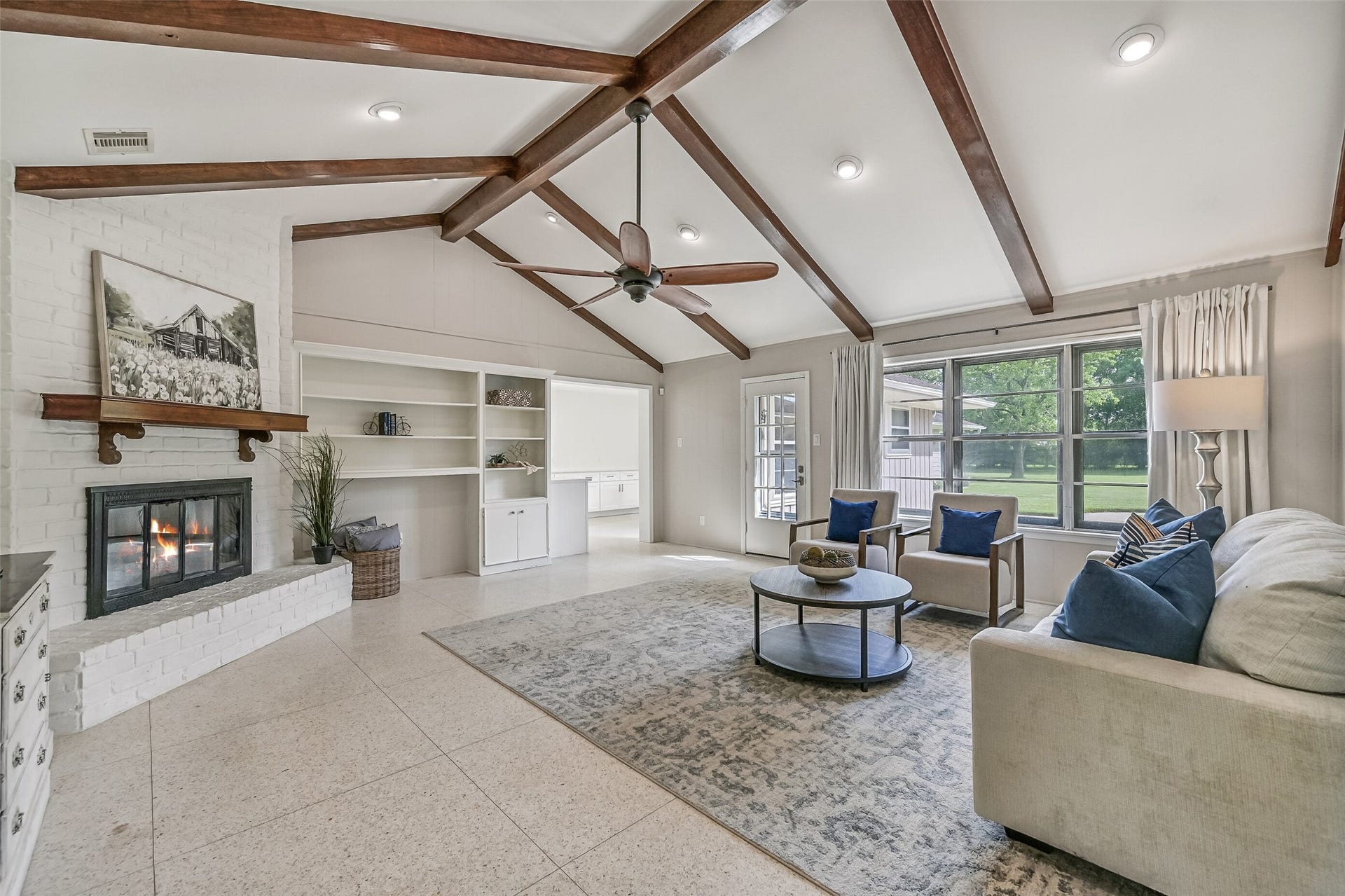 304 Chester Drive, Friendswood, TX 77546 Family Room First Residence:
Architectural built-in shelving anchors one wall, while a full wall of windows floods the family room with natural light and provides direct access to the concrete back patio. A wide entrance leads into the kitchen an breakfast room.