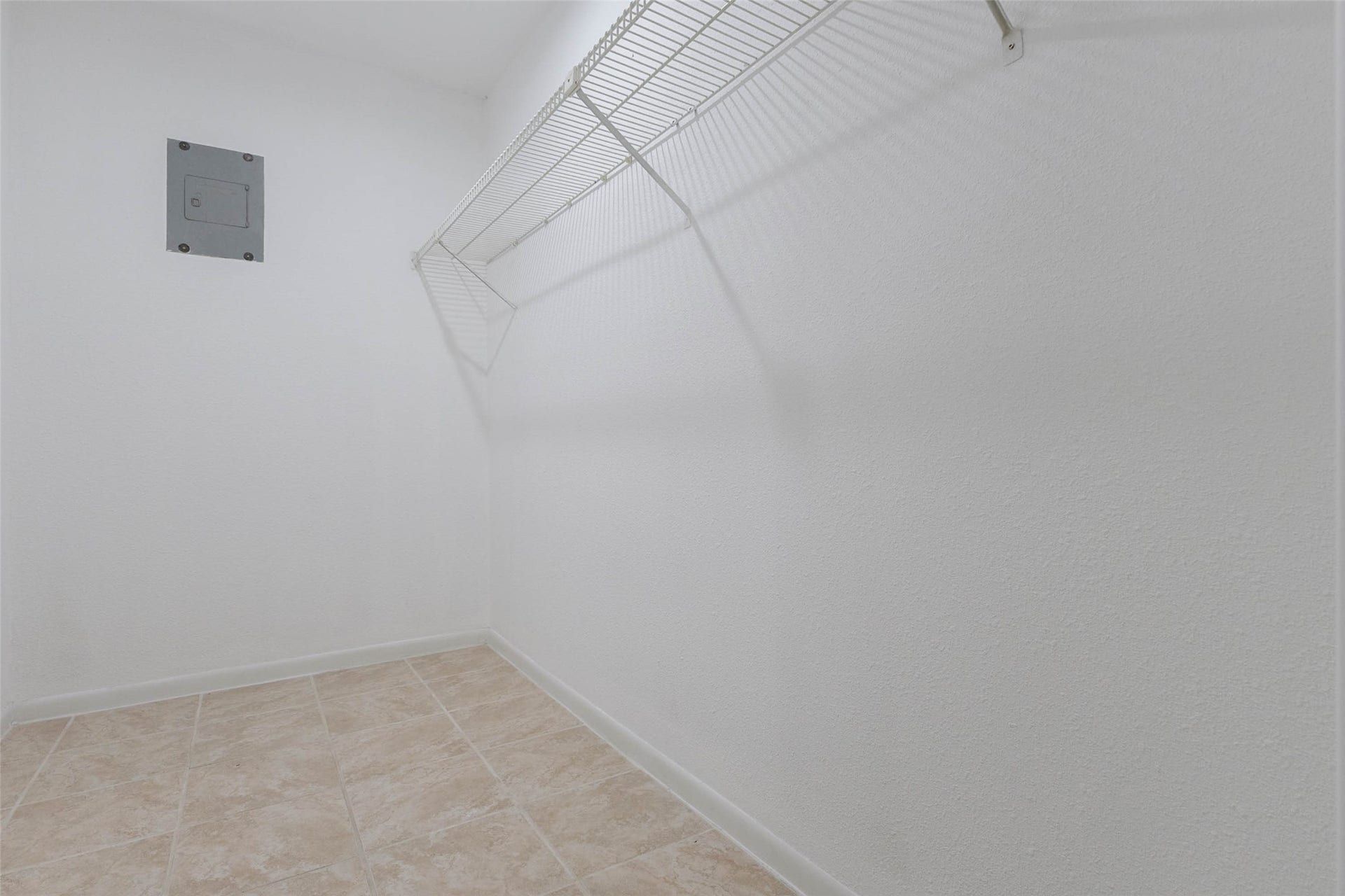 2800 Jeanetta Street, #2207, Houston, TX 77063 Spacious walk-in closet with tiled flooring and ample shelving for organized storage.