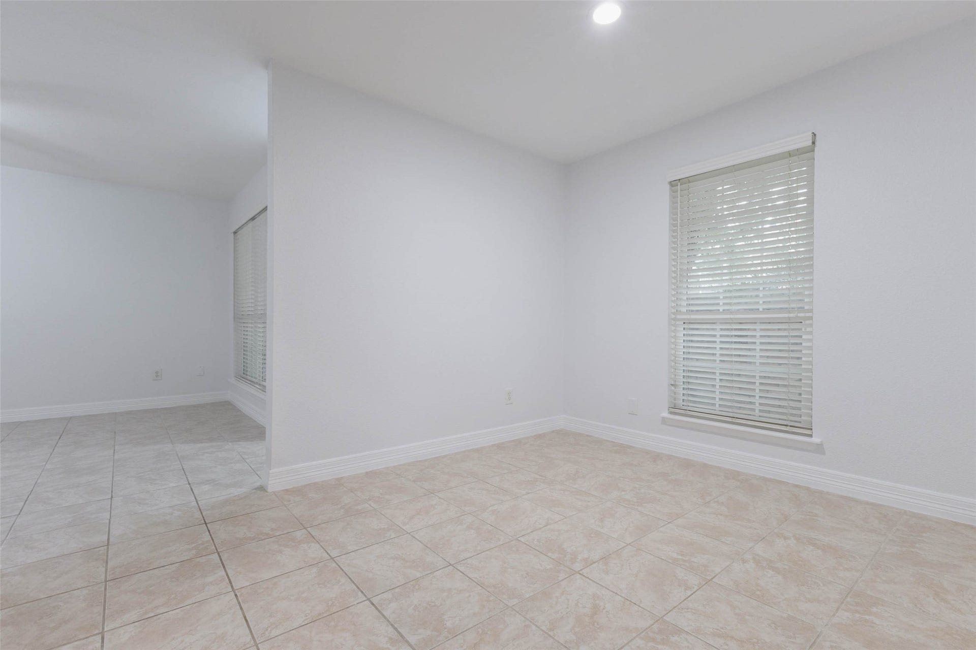 2800 Jeanetta Street, #2207, Houston, TX 77063 Bright and spacious room featuring neutral tile flooring, large windows with blinds, and a clean, open layout ideal for versatile use.