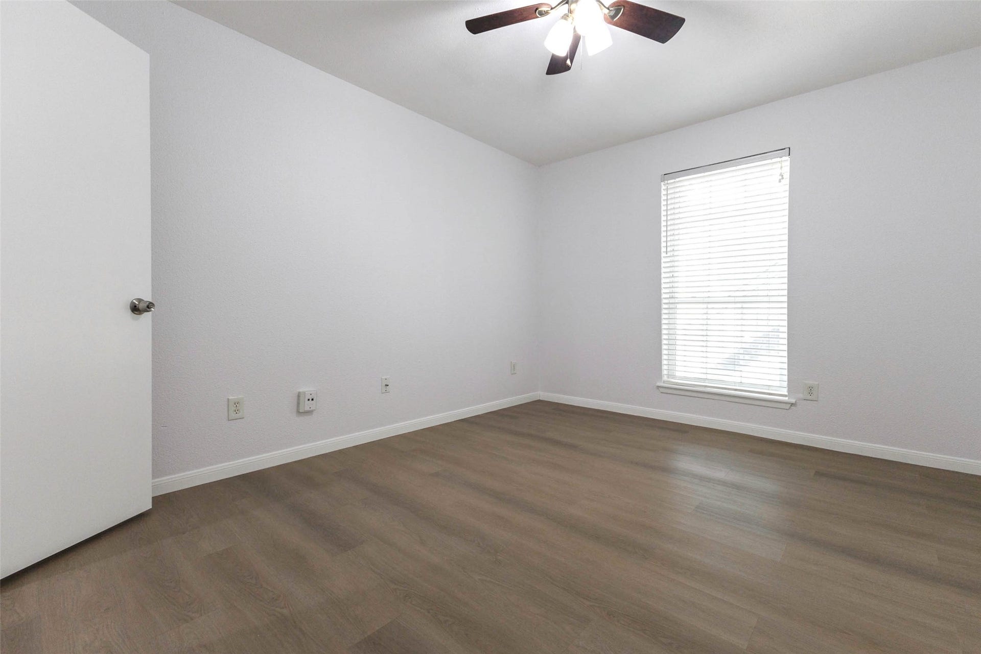 2800 Jeanetta Street, #2207, Houston, TX 77063 Bright and inviting room with a sleek ceiling fan, modern wood flooring, and a large window for natural light.