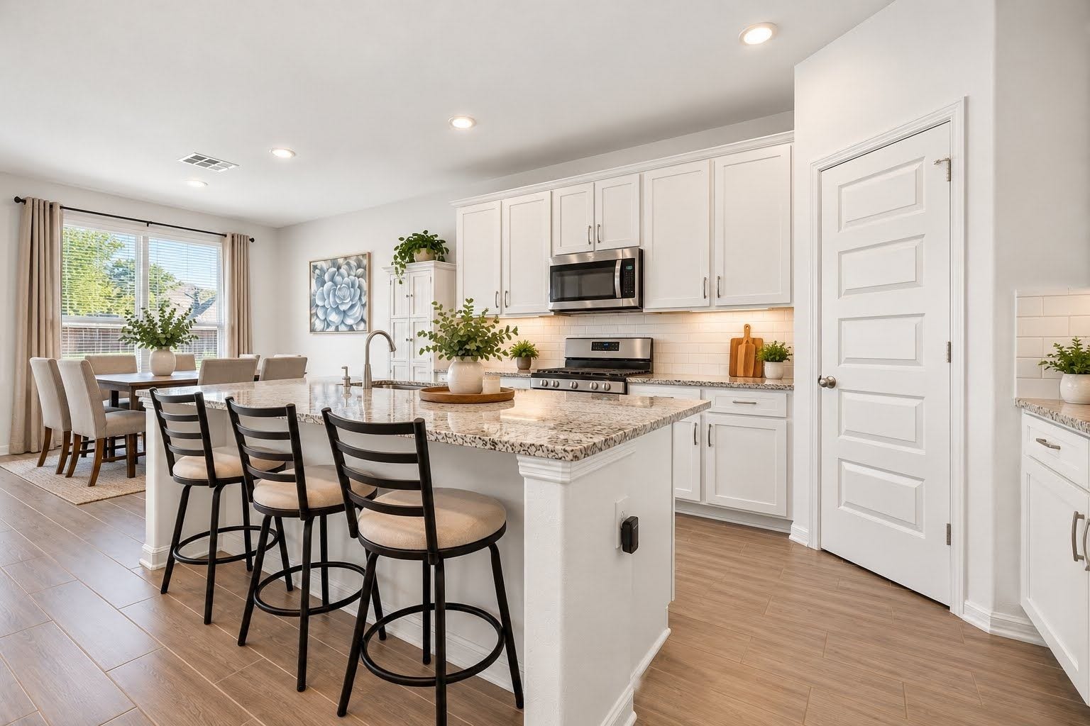 Large breakfast area, and room for 3 barstools at breakfast bar.