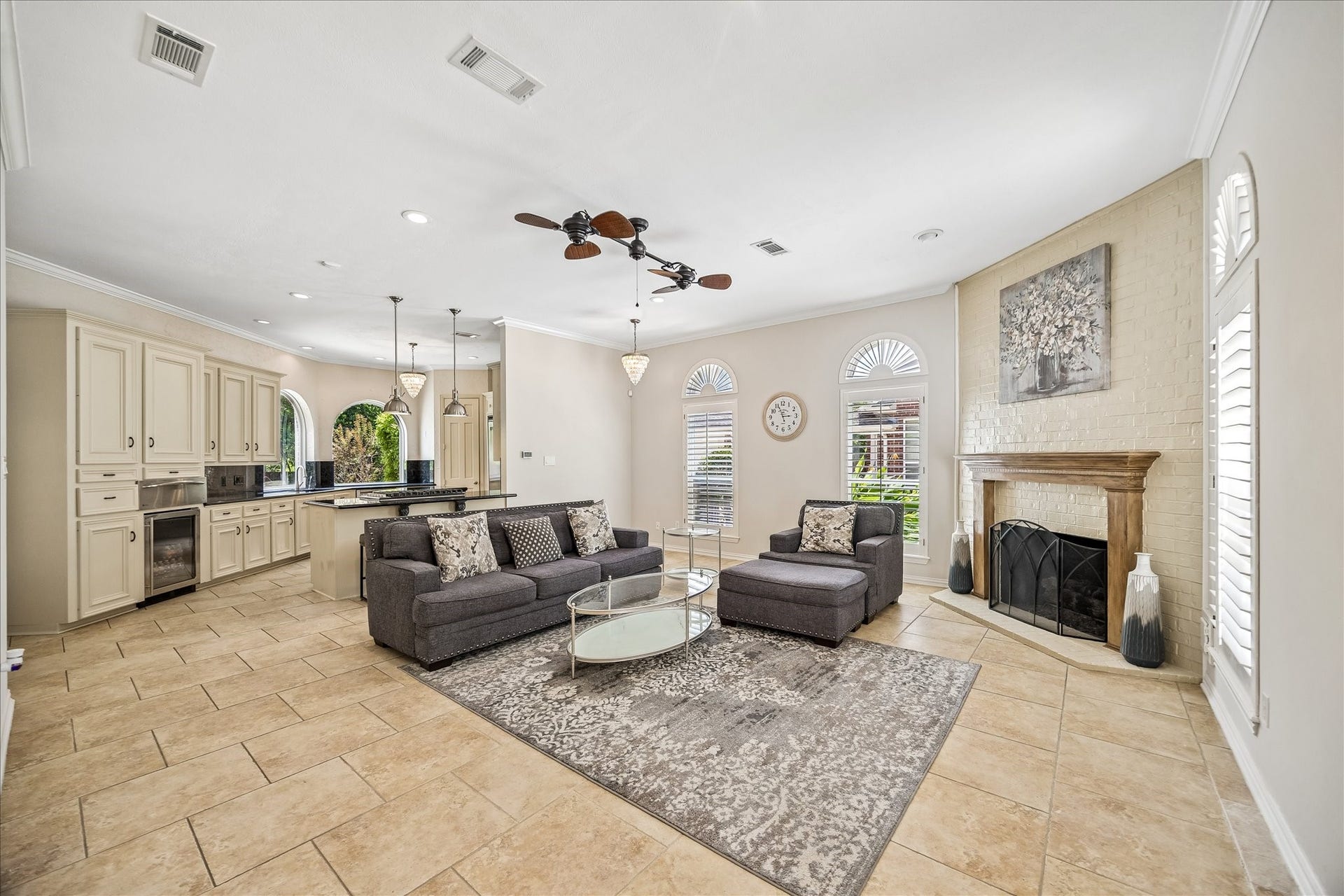 This spacious, open-concept den features a cozy fireplace and flows seamlessly into the kitchen.