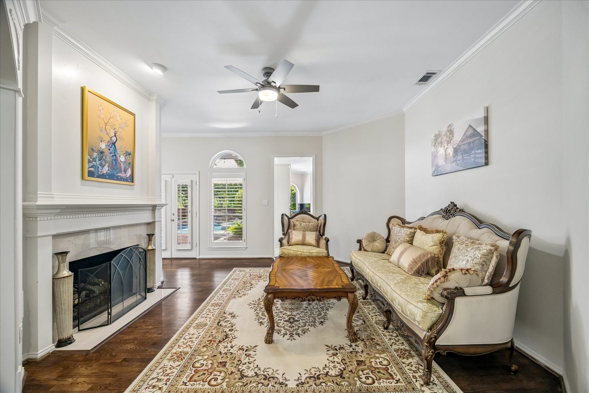 The formal living room offers expansive views of the backyard pool and spa-- creating a seamless connection between indoor comfort and outdoor living.