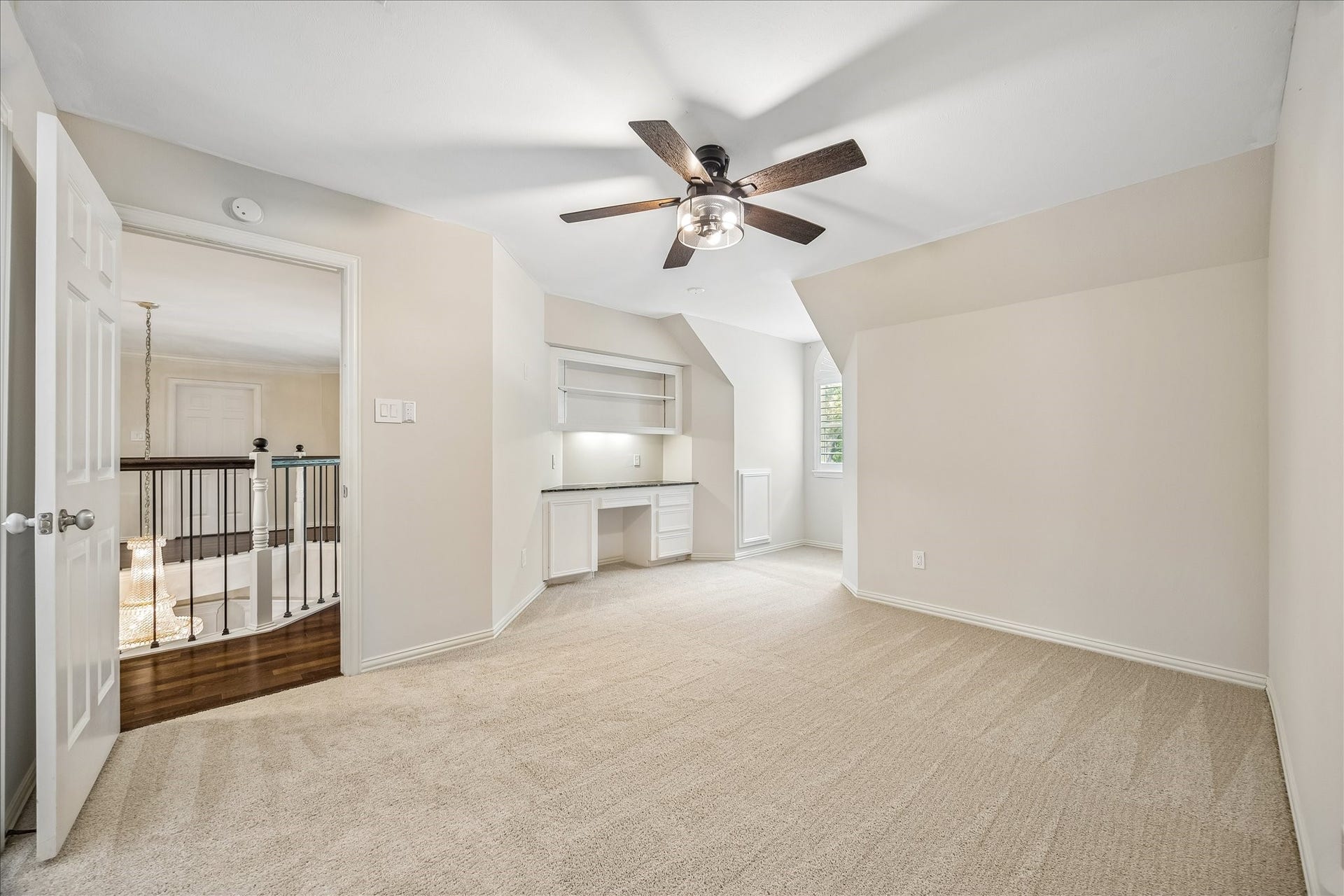 This additional secondary bedroom features a convenient built-in desk area, offering both functionality and versatility. The thoughtfully designed space is ideal for work, study, or creative use, while maintaining a comfortable and inviting bedroom setting.