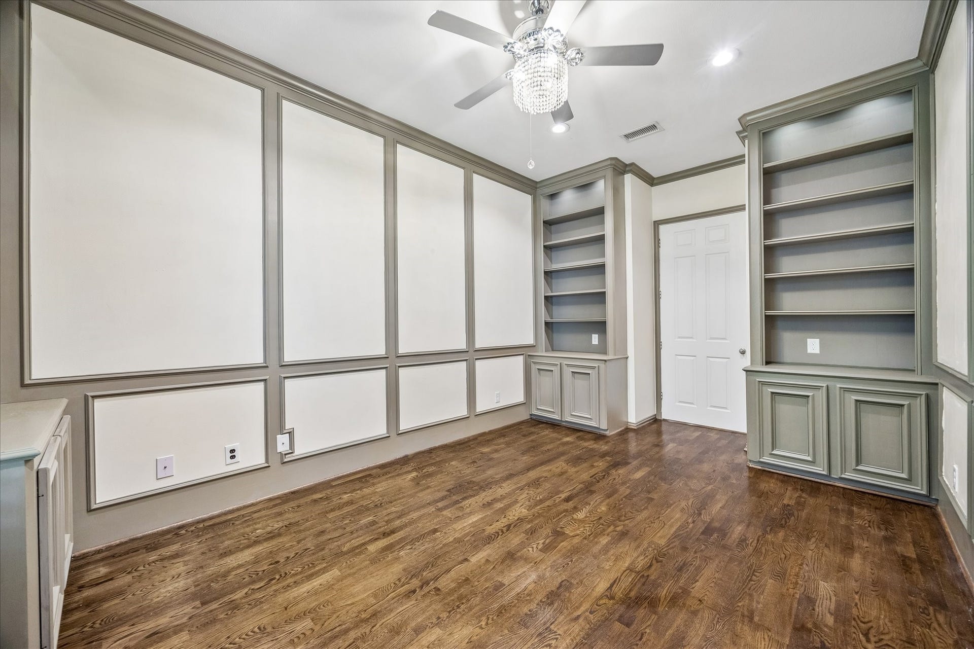 Hardwood floors and elegant wall paneling add a refined touch of sophistication.