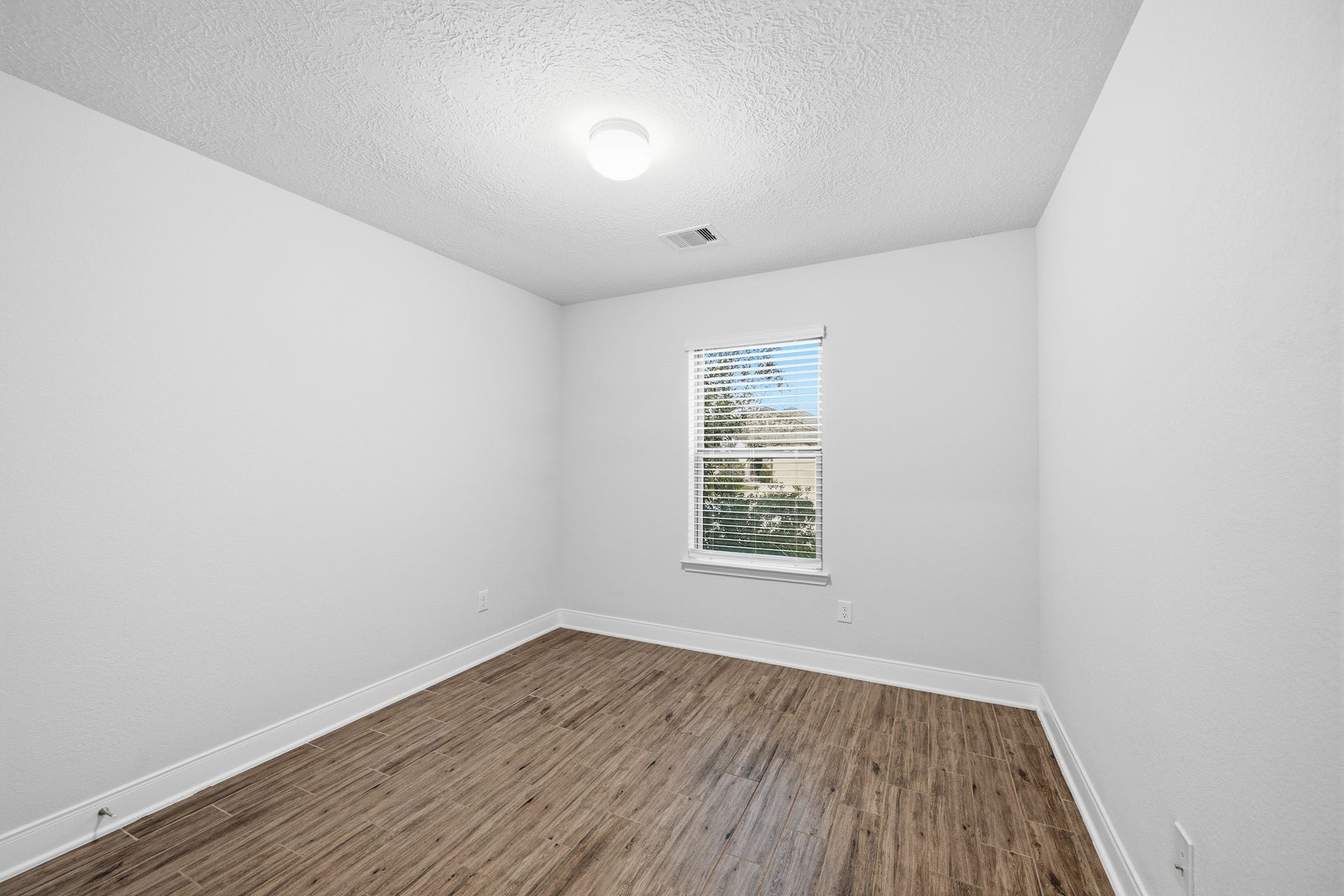 10314 Russell Pines Drive, Rosharon, TX 77583 Bedroom 3 offers sleek flooring and crisp white walls, with a window for natural lighting.