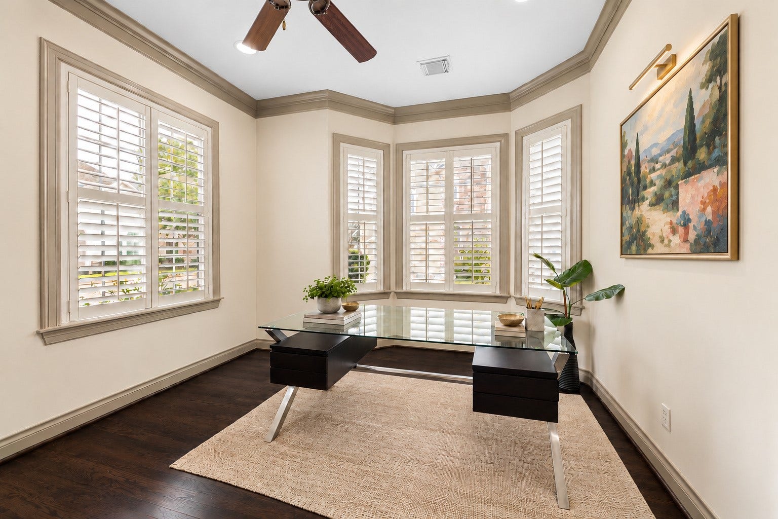 1311 N Jordan Cove, Houston, TX 77055 Beautiful light-filled formal living/study located to the left of entry. Four large windows w/ plantation shutters overlook the front exterior. Hardwood flooring, crown molding, recessed lighting, ceiling fan & arched entries enhance the timeless design. Flexible space makes an ideal home office, formal sitting room, playroom or piano room! Virtually staged art.