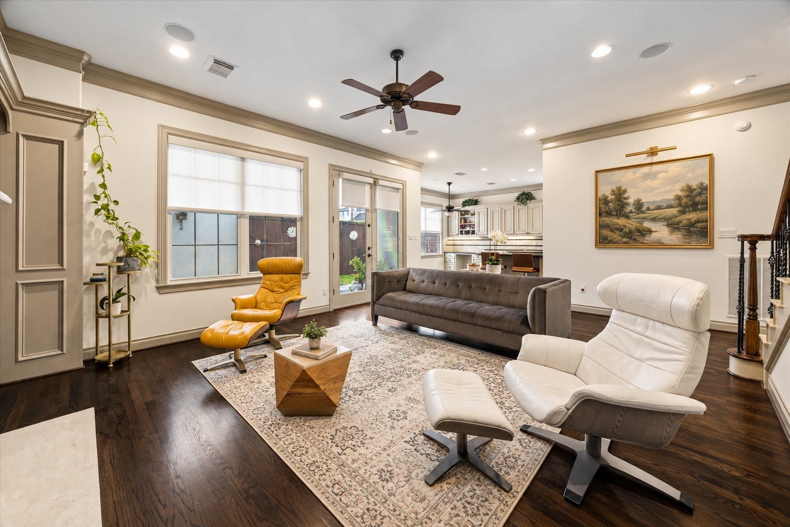 1311 N Jordan Cove, Houston, TX 77055 Another perspective of the spacious family room highlighting the thoughtful connection to kitchen & breakfast area. Open floor plan creates a seamless flow between main living spaces, ideal for everyday living & entertaining. French doors w/ Hunter Douglas shades lead directly to backyard patio, providing a wonderful extension of the living space. Virtually staged.