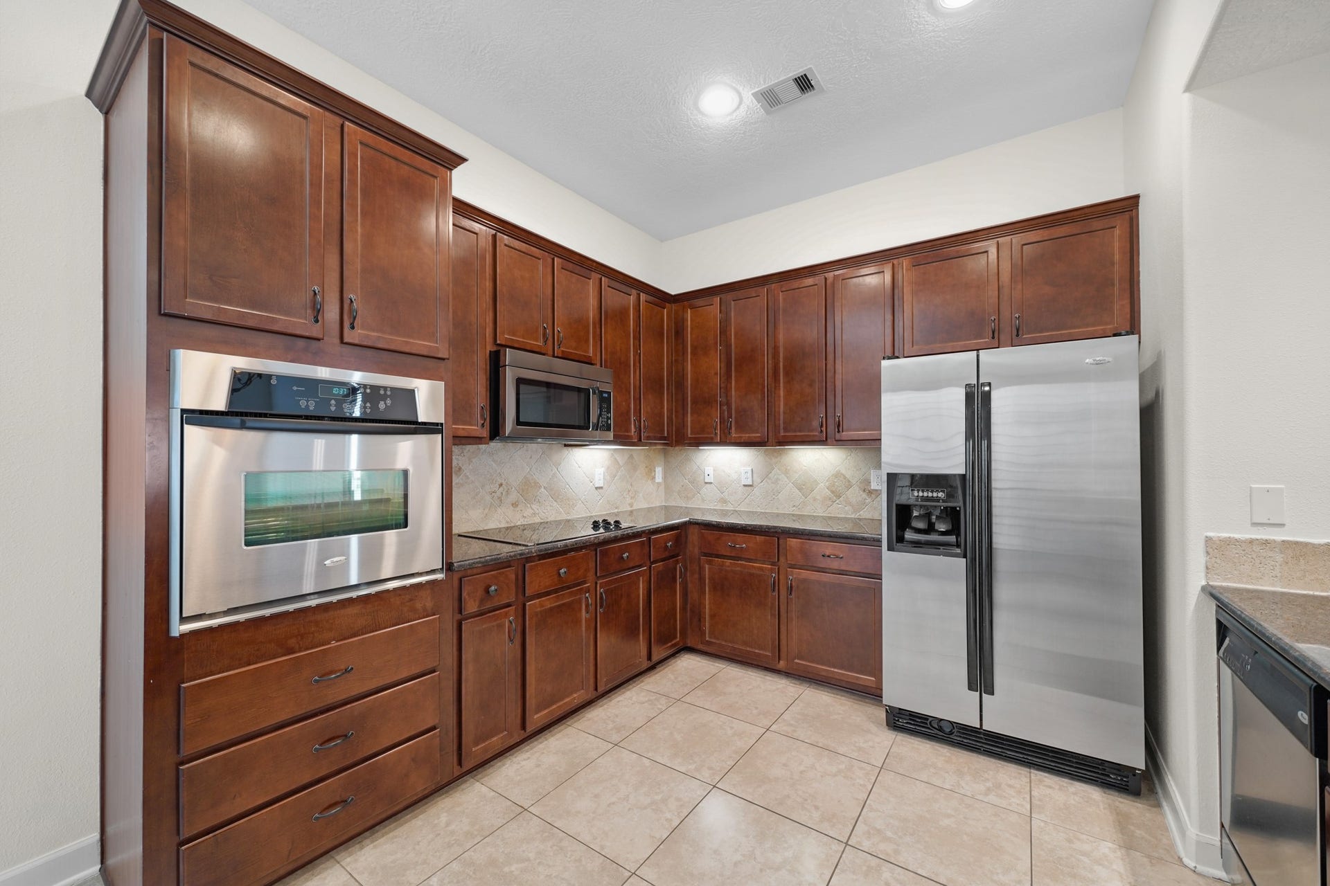 1717 Francis Street, Houston, TX 77004 The kitchen has tile floors, recessed lighting, stainless steel appliances, tons of cabinetry for storage, and under cabinet lighting.