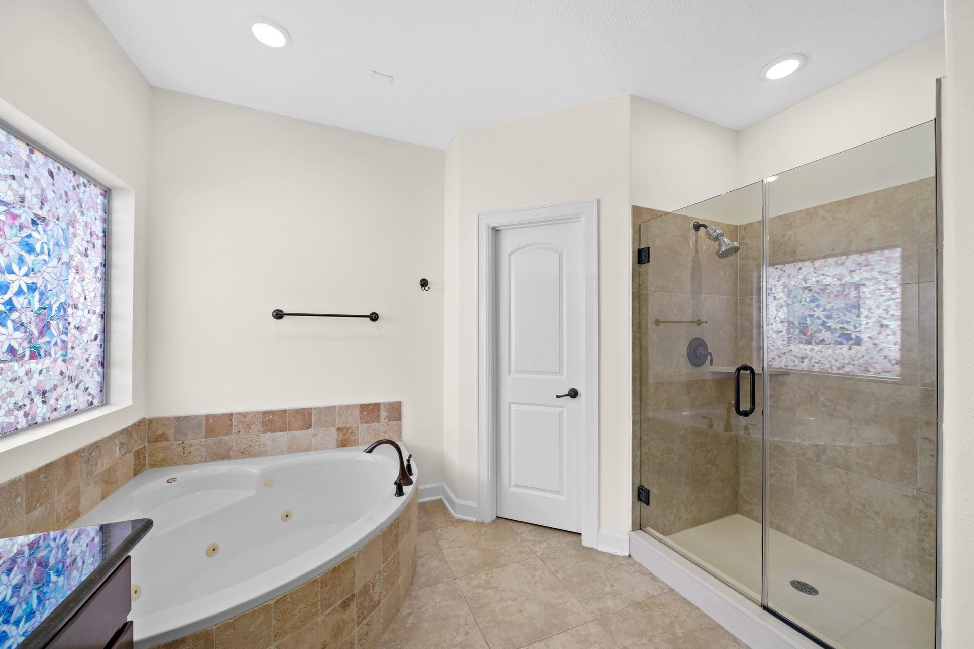 1717 Francis Street, Houston, TX 77004 The master bath is highlighted by a jetted tub, private frozen glass window, recessed lighting, and a walk-in glass enclosed shower.