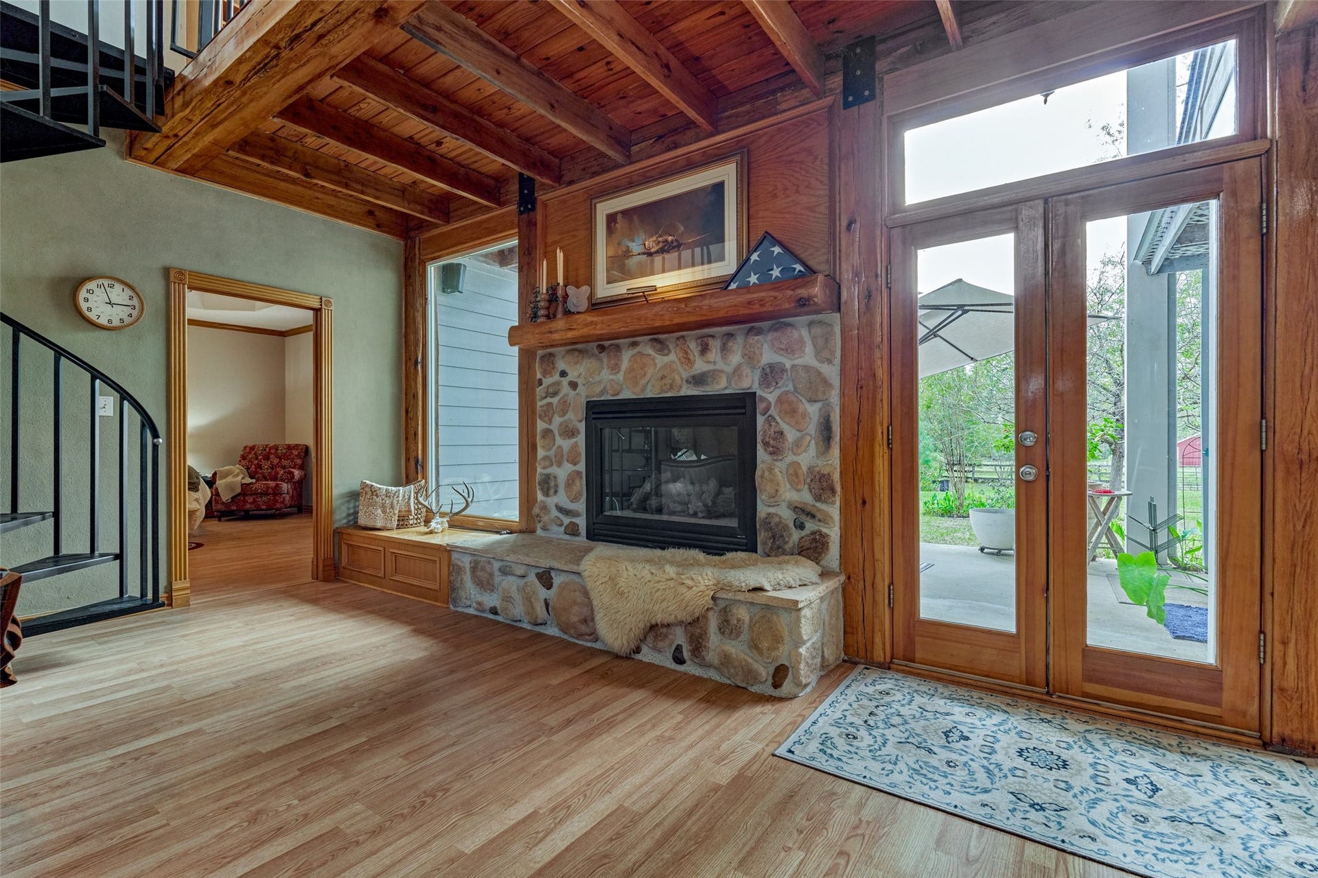 28911 Sapphire Circle, Magnolia, TX 77355 Large gas log - stone fireplace with large custom windows and double doors to back covered patio area overlooking acreage.