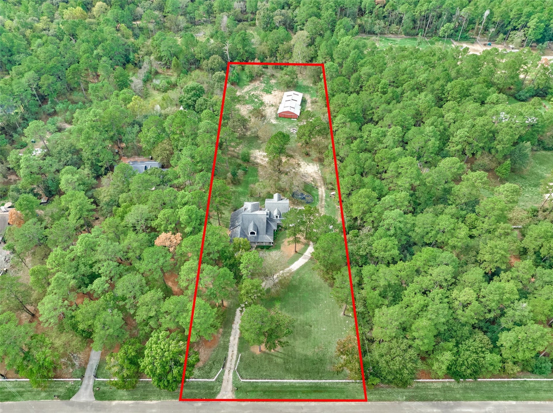 28911 Sapphire Circle, Magnolia, TX 77355 Expansive three-acre wooded property nestled within lush greenery, offering privacy and plenty of room for horses or animals, backs up to the neighborhood 7-mile equestrian trail.