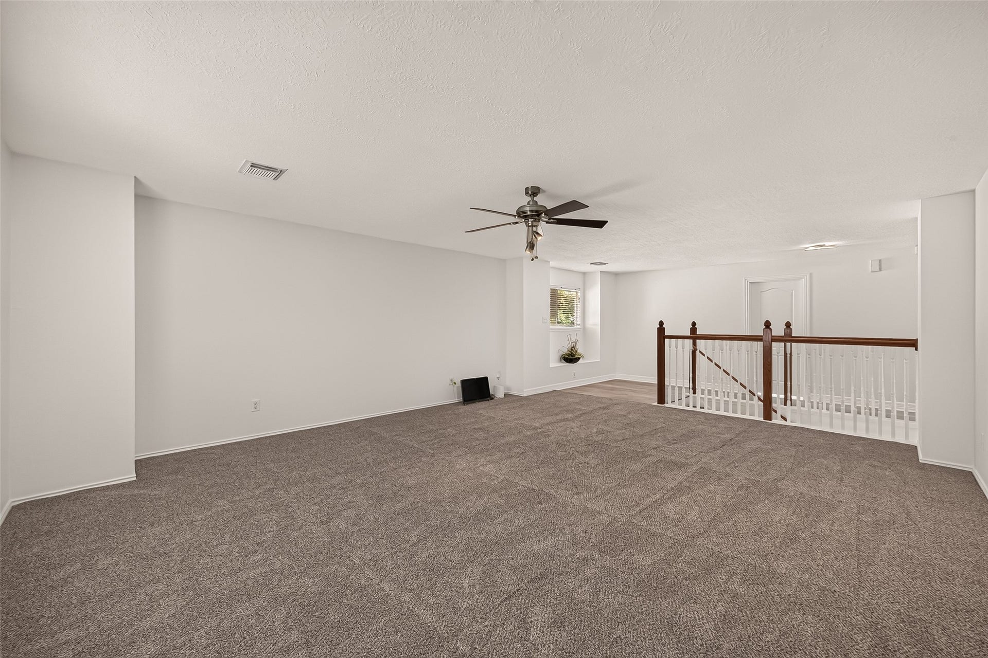 3111 Lantern Bay Lane, Katy, TX 77449 The upstairs game room offers plenty of room for movie nights, games, or a second living area, with an open view toward the staircase.