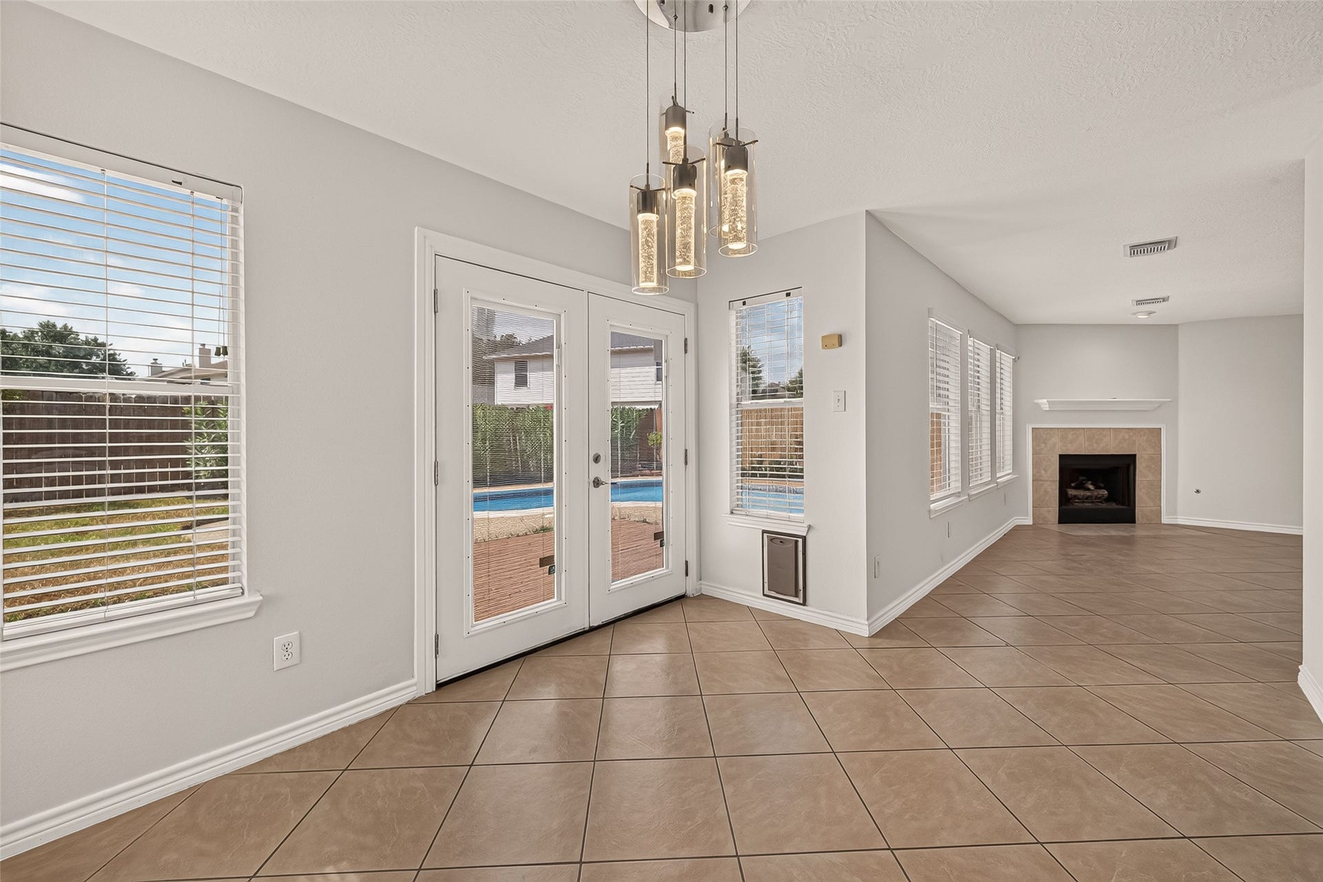 3111 Lantern Bay Lane, Katy, TX 77449 Start the day with a view of the pool from this bright breakfast area, then step through the French doors to enjoy the patio, with blinds across all of the windows.