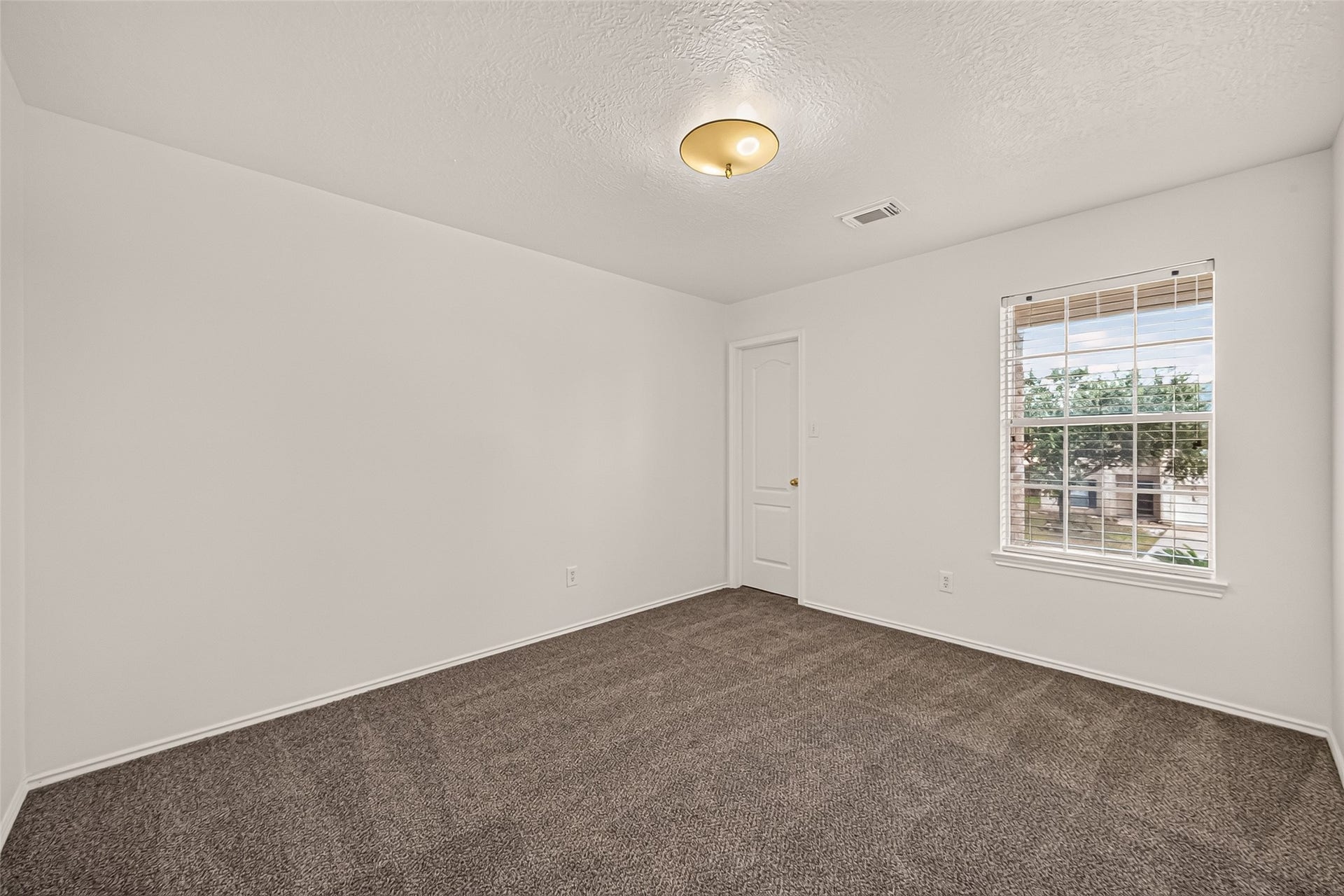3111 Lantern Bay Lane, Katy, TX 77449 A bright first guest bedroom with soft carpeting, a generous window, and a versatile layout ready to make your own.