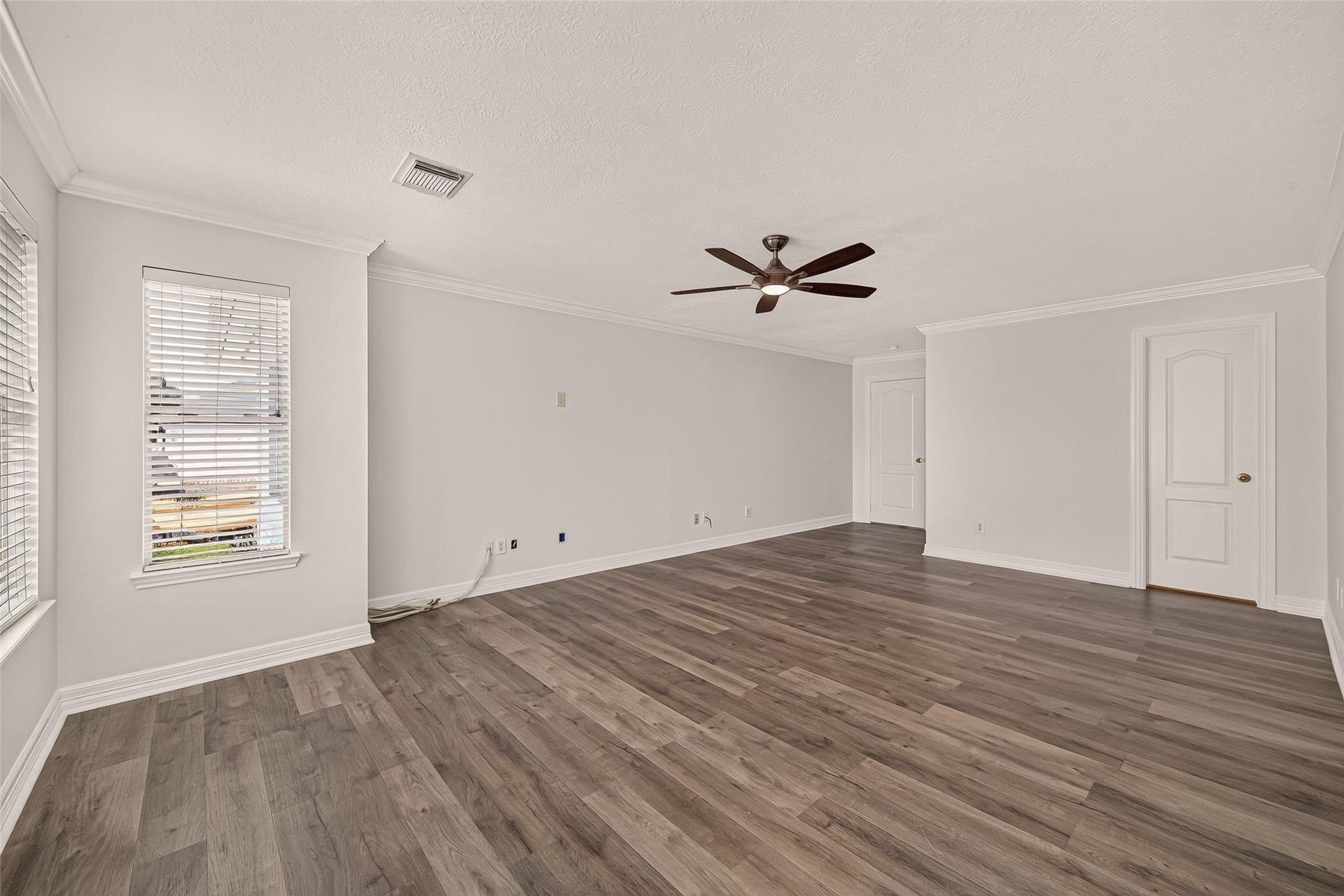 3111 Lantern Bay Lane, Katy, TX 77449 Natural light, and vinyl flooring give the spacious primary bedroom a bright, polished feel, with plenty of room for a king size bed